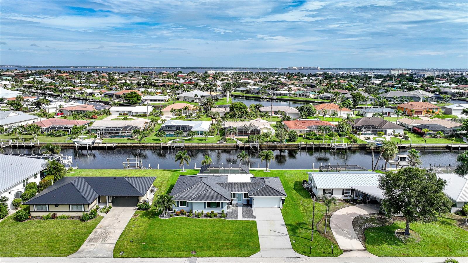 Welcome to 440 Capri Isles Court — a turn-key waterfront masterpiece in the heart of Punta Gorda. This fully renovated home blends sleek, modern elegance with the essence of Florida luxury living. Every detail has been carefully curated, showcasing impeccable style, premium finishes, and thoughtful craftsmanship throughout.
Inside, soaring ceilings and abundant natural light create a bright, airy atmosphere. The open-concept design flows effortlessly, anchored by a stunning gourmet kitchen featuring quartz countertops, custom cabinetry, high-end appliances, and a contemporary aesthetic that is as functional as it is beautiful. The living and dining areas are designed for both everyday comfort and stylish entertaining, with impact windows framing breathtaking water views.
The owner’s suite is a serene retreat with spa-inspired bath and generous closet space, while additional bedrooms provide comfort and flexibility for family or guests. Every fixture, finish, and feature reflects the home’s complete transformation into a modern showpiece.
Step outside and experience true Florida living. The expansive patio and sparkling pool are enhanced by a picture-view screen, ensuring uninterrupted water vistas and golden sunsets over the Swordfish Strait. Whether lounging by the pool, hosting guests, or enjoying the peaceful ambiance, this outdoor haven was designed for relaxation and style.
This home also delivers peace of mind with impact-rated windows, a new roof, and robust flood gates — a rare and valuable feature that underscores both safety and resilience. Thoughtfully updated from top to bottom, this property is truly turn-key and ready to be enjoyed immediately.
Set along one of Punta Gorda’s most desirable waterways, Swordfish Strait, this residence is more than a home — it is a sophisticated Florida oasis, offering the perfect blend of luxury, functionality, and waterfront lifestyle.
Don’t miss this rare opportunity to own one of the area’s most stunning and secure waterfront properties. Schedule your private showing today and experience the unmatched beauty of 440 Capri Isles Court.