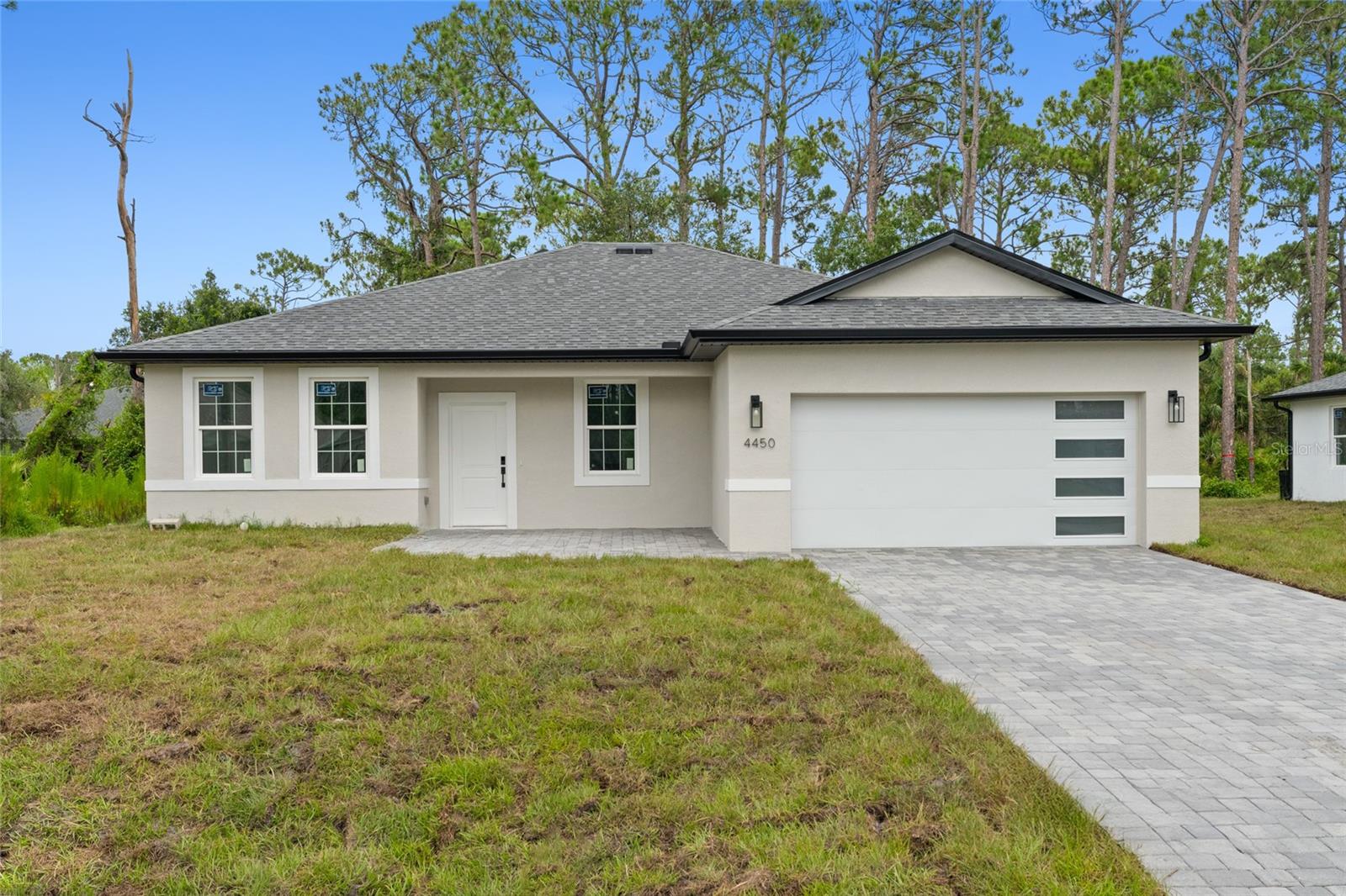 Under Construction. Home is fully completed, pending final inspection for Certificate of Occupancy. THIS PROPERTY QUALIFIES FOR CLOSING COSTS ASSISTANCE PLUS AN ADDITIONAL 1% INCENTIVE WHEN USING BUILDER’S PREFERRED LENDER
Brand new concrete block construction in the heart of North Port — no HOA, no CDD, and no flood zone (X). This beautifully crafted 4-bedroom, 3-bathroom home offers an elegant open floor plan with a epoxy finished two-car garage, and premium finishes throughout.
The gourmet kitchen features a large center island with waterfall-edge quartz countertops on both sides, soft-close cabinetry, stainless steel Samsung appliances — ideal for entertaining and everyday living. Luxury vinyl plank flooring flows throughout the home, offering style and durability.
The spacious primary suite includes his-and-hers walk-in closets and a bathroom with dual sinks and a glass-enclosed walk-in shower. A secondary bedroom includes a private en-suite bath, and a walk-in closet perfect for guests or multi-generational living. All bedrooms with blinds and modern celling fans.
Additional features include impact-resistant windows and doors, a smart thermostat, upgraded lighting, a water filtration system, and garage doors with glass panels that allow natural light in. Enjoy Florida living year-round on the covered lanai with a nicely sized backyard and extended paver driveway.
Easy access to I-75, commuting to Sarasota, Fort Myers, and top-rated Gulf Coast beaches like Siesta Key and Venice Beach. An excellent opportunity for homeowners and investors alike!
Schedule your private showing today!