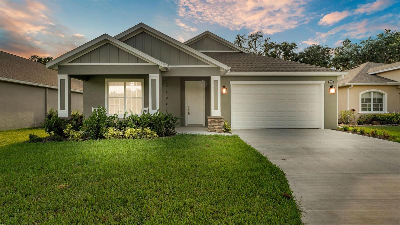 Welcome to your dream home on the water! This brand-new lakefront residence blends timeless craftsmanship with modern design, offering the perfect balance of elegance, functionality, and everyday comfort. Inside, the thoughtfully designed floorplan features three bedrooms, two-and-a-half bathrooms, and a dedicated home office—ideal for today’s lifestyle needs. Tray ceilings and crown molding add architectural detail and sophistication, while wide plank luxury vinyl flooring provides both durability and style throughout the main living spaces. At the heart of the home, the gourmet kitchen is a showpiece. Outfitted with two-toned cabinetry, a large island with bar-style seating, a closet pantry, and stainless-steel appliances, it’s the perfect space for cooking, gathering, and entertaining. The open layout allows the kitchen to flow seamlessly into the living and dining areas, all while enjoying beautiful lake views. The spacious primary suite is a true retreat, complete with dual walk-in closets and a spa-like en suite bathroom boasting a walk-in shower, and dual vanities. Secondary bedrooms offer comfort and flexibility, while the home office provides privacy and productivity for remote work or study. Set on a pristine lakefront lot, this home offers not just luxury finishes but also the tranquility of waterfront living. Whether you’re enjoying morning coffee on the patio, hosting friends in your open-concept living space, or retreating to your private suite, this home delivers an unparalleled lifestyle. Don’t miss the opportunity to make this new construction lakefront gem your own.