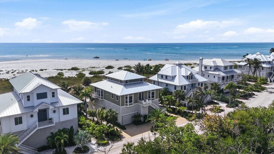 Welcome to coastal perfection at Palm Island Resort on exclusive Palm Island, where panoramic views of Stump Pass and the Gulf of Mexico create a breathtaking backdrop for everyday living. This beautifully designed 3-bedroom, 3-bath beachfront residence captures the essence of island elegance, with an open floor plan thoughtfully oriented to maximize water views from nearly every room. Custom finishes shine throughout, including large porcelain tile flooring in the main living areas, heated floors in all bathrooms, and a seamless flow between the kitchen, dining, and living spaces. The living room is both inviting and serene, featuring a built-in bookshelf and charming window seat—perfect for relaxing with a book while coastal breezes drift in through a wall of sliding glass doors leading to the expansive screened lanai.
Two guest bedrooms on the main level provide privacy and comfort, while the upstairs primary suite is a true retreat. Wake to sweeping water views and unwind each evening on your private sun deck as the sun sets over the Gulf. The suite also offers a spacious walk-in closet and a luxurious ensuite bath complete with soaking tub, walk-in shower with rain head, and dual vanities. Designed with both luxury and practicality in mind, the home includes an elevator servicing the main living level, central vacuum system, fire sprinkler system, wine cooler, hurricane-impact windows and doors with remote controlled Kevlar hurricane curtains for additional protection on the screened lanai, and a Halo whole-house water filtration system. Exterior features include durable Hardie Board siding (face-nailed for added strength), composite decking with marine-grade stainless steel, solid soffits, a newer metal roof, and updated AC systems. Outdoor living is equally impressive, with an open sun deck ideal for soaking up the Florida sunshine, a salt system hot tub for relaxing evenings under the stars, and lush tropical landscaping. The ground level offers a solid concrete foundation, golf cart garage, ample storage, and an outdoor shower—perfect after a day at the beach. Life at Palm Island Resort is truly a destination experience, offering private shell-strewn beaches, frequent dolphin and manatee sightings, tennis, pickleball, fitness center, dockage, clubhouse, and on-site dining at Rum Bay Restaurant, plus treats from Coconuts Ice Cream Shop. Accessible by a 3-minute car ferry ride and designed for golf cart and bicycle travel, this gated community with security and bell service delivers the ultimate in peaceful island living.  Unspoiled, unforgettable, & simply paradise.