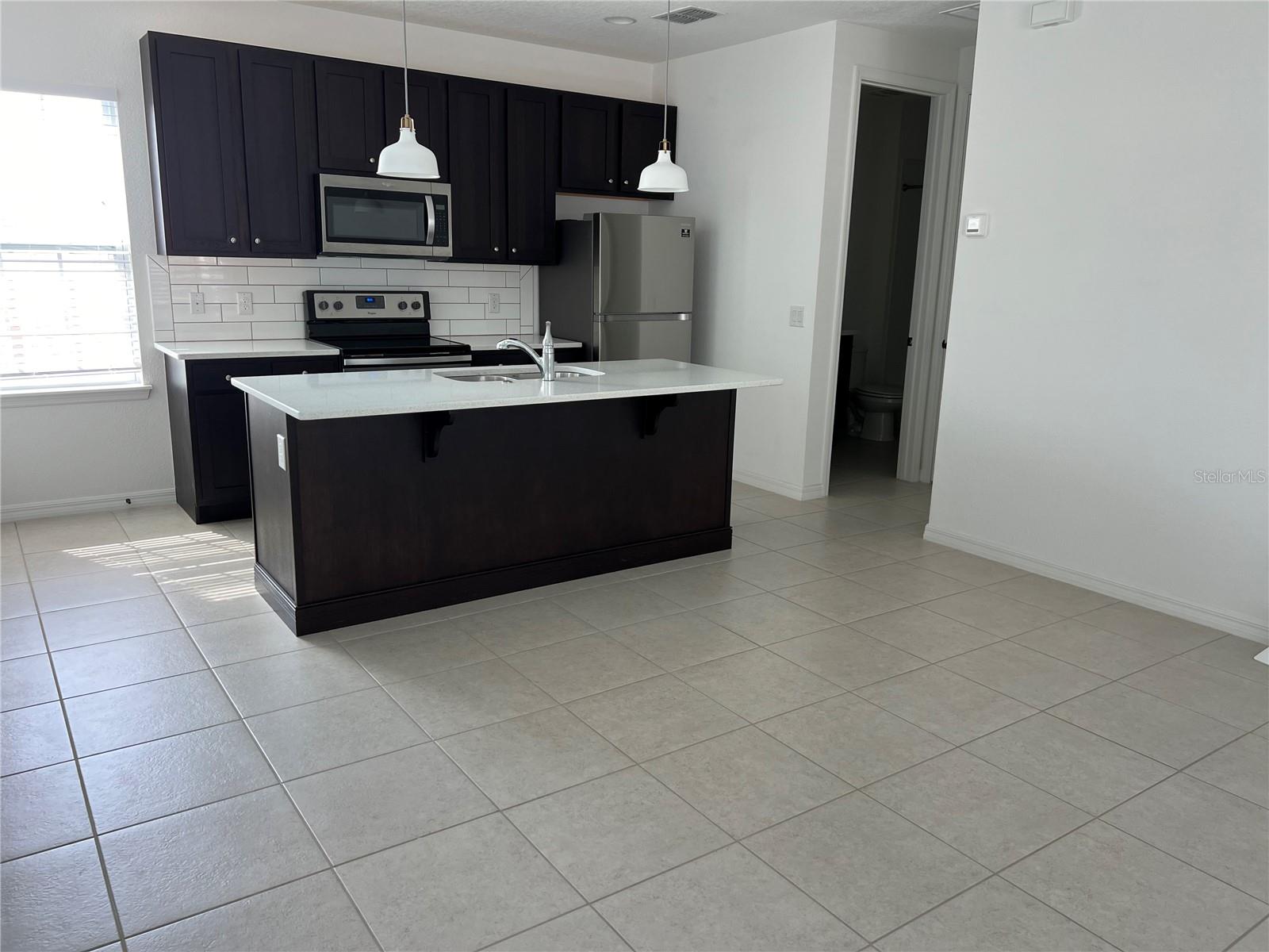 Light and Bright! This one bedroom efficiency has high ceilings and extra windows for an open airy feel. There is one designated parking space right outside the door which is unusual for the garage apartments in Laureate Park. Additional street parking available for guests. Association membership is required for $200 per year but gives you access to community gym, resort style pools, parks and playgrounds.