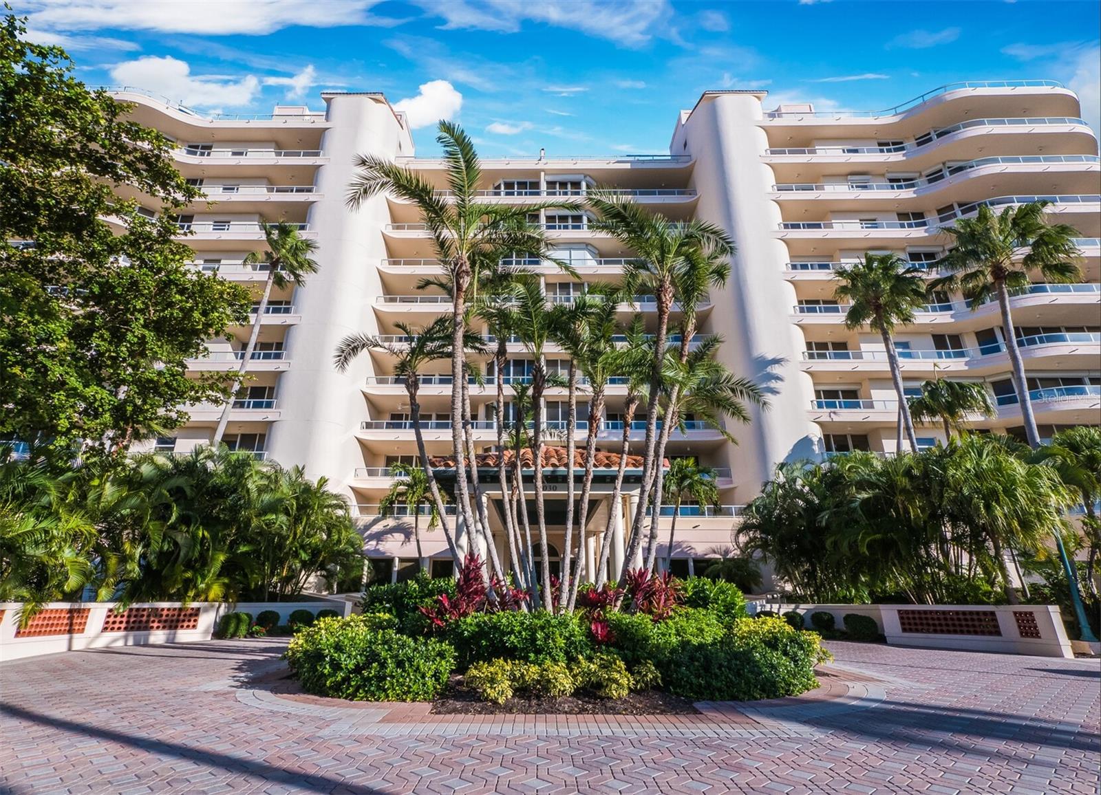 Located in the Grand Bay community on Longboat Key, this spacious 3BR residence offers stunning views and desirable extras, including 2 conveniently located parking spaces. The pet friendly community allows up to 2 large dogs. The home features luxury vinyl flooring and neutral tones throughout, with floor-to-ceiling windows and plantation shutters that let in natural light. Elevated ceilings and accent lighting create an open, airy feel, while you enjoy views of Harbourside Golf Course, Sarasota Bay, and the downtown skyline from the expansive wraparound terrace that is perfect for entertaining or relaxing. The updated kitchen includes white cabinetry, Corian countertops, tile backsplash, stainless steel appliances (including a new Sub-Zero refrigerator), and a central island. The living room/dining room offers ample space for a formal dining room table and large seating area. The primary suite is a private retreat, with access to the terrace and a primary bath featuring dual vanities, a walk-in shower, and a spa tub. The large custom closet is thoughtfully designed for ample storage. A full-size laundry room adds convenience. Grand Bay offers resort-style amenities including 24-hour gated security, a clubhouse with a library and game room, fitness center, 2 Har-Tru tennis courts, 2 heated pools, and a spa. Residents also enjoy deeded beach access through the Bay Isles Beach Club, just a short bike ride away. This private beach offers a peaceful, uncrowded environment, with a beachside pavilion, restrooms, and showers. Additionally, for those seeking more exclusive amenities, the optional Longboat Key Club provides access to luxury services, including golf, fine dining, a full-service spa, and fitness facilities.