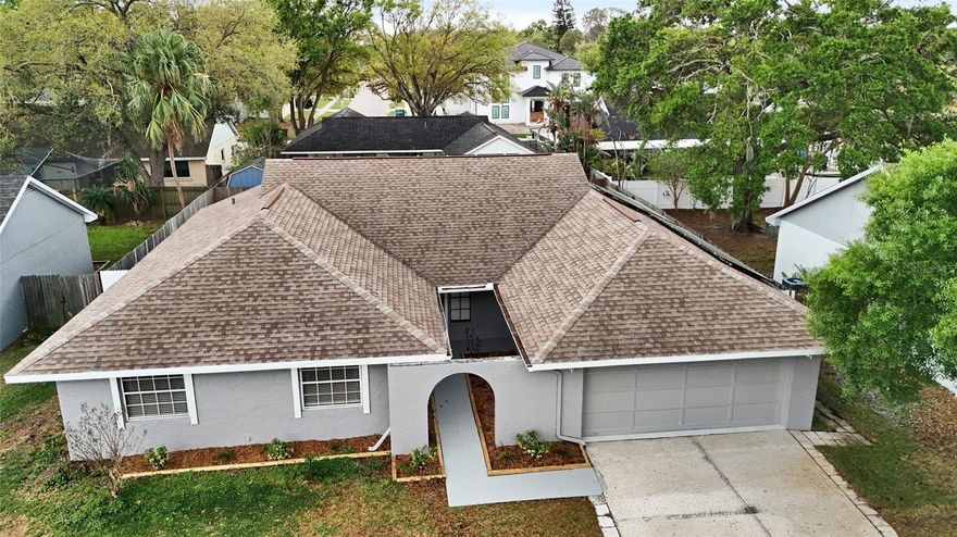 Welcome Home!!! Come check out this beautifully remodeled and spacious (1910 SF) 3-bedroom home which includes an office/den, 2 full bathrooms and 2 car garage. This remodeled one story, block construction POOL home in the highly sought-after Carrollwood area of Tampa has tons of upgrades. Its features include a new designer kitchen with custom wood cabinets, gorgeous QUARTZ countertops and back splash, and stainless-steel appliances. It also has 2 newly remodeled bathrooms with wood cabinets/vanities and sparkling quartz counter tops. Additionally, it has new durable laminate wood flooring throughout the entire home (no carpet), new light fixtures, ceiling fans, sinks, faucets and door hardware. The home has been meticulously painted inside and out.  It boasts a newer roof (2021) and solar panels (2023 -paid in full) which is great for lowering your power bills. It has a spacious split floor plan which includes a big kitchen, large living room, and a HUGE dining room which could be split into 2 rooms (family room & formal dining). The home office / den could easily be converted into a 4th bedroom. This amazing property also has a covered back patio that overlooks a sparkling caged in pool and a fenced in back yard that is perfect for entertaining all year round. FLOOD ZONE X = no mandatory flood insurance needed. Just move in and enjoy, with peace of mind knowing that the home needs nothing done to it. Schedule your private viewing of this turn-key home today.