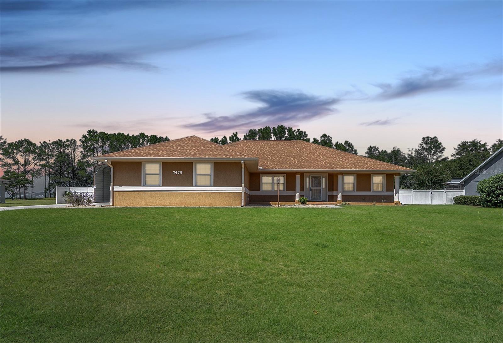 Live the Florida Dream in Green Meadows—No HOA, Just Pure Possibility! Step into serenity and style with this beautifully crafted and spacious custom home, which combines comfort, style, and functionality, making it ideal for enjoying the Florida lifestyle. With a newer roof, no HOA, and over half an acre of land backing up to open meadow views, this property offers the freedom and tranquility you’ve been searching for. The inviting covered front porch sets the tone for relaxed living and warm hospitality found within the open floor plan, which features elegant crown molding, soaring vaulted ceilings in the formal living and dining areas, and durable tile flooring throughout. A separate family room provides additional space for entertaining, enhanced by a tray ceiling, recessed LED lighting, and glass-inset French doors that open to a versatile Florida room. The kitchen is thoughtfully designed with stainless steel appliances, granite countertops, a tiled backsplash, a pantry for extra storage needs, and casual bar height seating. The kitchen space conveniently overlooks the family room, creating a seamless flow for everyday living and gatherings. The owner’s suite is a true retreat, featuring a tray ceiling, dual walk-in closets, and large windows that fill the space with natural light. The spa-like en-suite bathroom offers double vanities, a walk-in shower, and a separate soaking tub for relaxation. Outside, the 0.52-acre lot provides perfect space for endless possibilities, whether you envision a garden oasis, a sparkling pool, or an outdoor recreation space. Additional features include a spacious covered patio with uninterrupted meadow views, vinyl fencing for added privacy, a recently added 3rd bedroom, and an irrigation system. The property also offers an oversized two-car garage and a generous RV carport equipped with a 30-amp hookup and sewer dump, perfect for storing boats, ATVs, and other outdoor gear. This home is conveniently located in a quiet and walkable neighborhood but still close to nearby shopping, dining, public parks, and medical facilities, and is just a short drive to The Villages. Outdoor enthusiasts will appreciate nearby attractions such as Silver Springs State Park for kayaking and camping, Lake Weir for boating and fishing, and Baseline Golf Course, less than 5 miles away. This property isn’t just a home—it’s your invitation to embrace the Florida lifestyle, where privacy, comfort, and convenience come together seamlessly. Opportunities like this don’t come often—make it yours today!