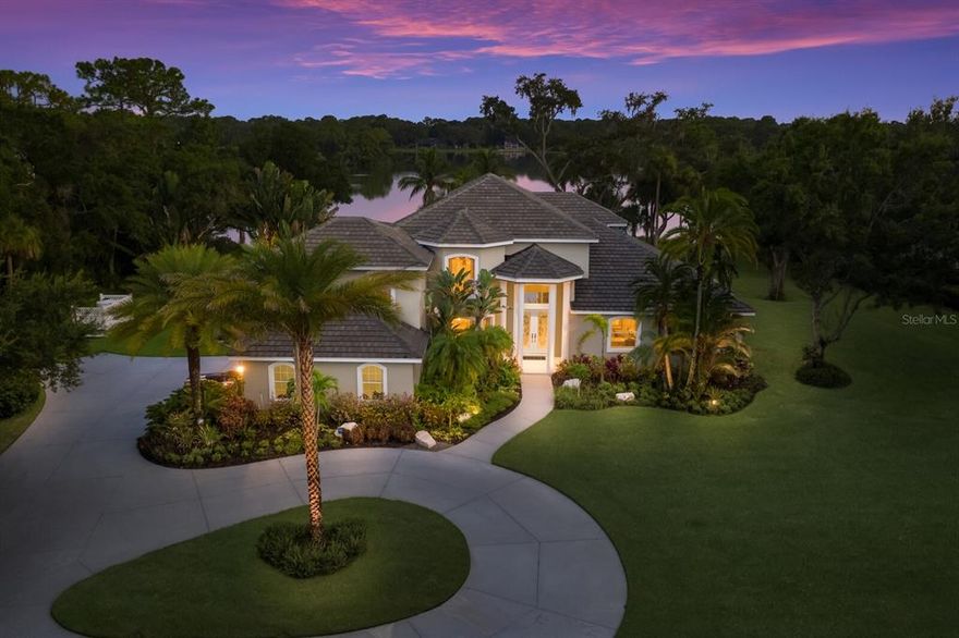 SPECTACULAR 4 BED + den / 4.5 BATH / 3 CAR GARAGE HOME WITH 4,953 SQ.FT. OF LIVING AREA FEATURING A TROPICAL POOL AND TIKI BAR ON A ONE-OF-A-KIND 2+ ACRE LOT WITH EXPANSIVE WATER VIEWS OF A 19 ACRE SPRING FED LAKE IN ONE OF SARASOTA'S MOST EXCLUSIVE ENCLAVES. If you dream of enjoying the ultimate outdoor Florida lifestyle and entertaining your friends and family in BACKYARD OASIS WITHOUT COMPARE, then look no further. THE SHOWSTOPPING POOL OF THIS LUXURY ESTATE FEATURES AN OUTDOOR TIKI BAR AND SEPERATE CABANA WITH OUTDOOR KITCHEN. The COVETED SOUTHERN EXPOSURE VIEWS of the tranquil lake and birdlife will truly take your breath away and must be experienced in person. Inside the home, you will find the large primary Master Bedroom on the first floor accompanied by a spacious sitting area along with an oversized closet. The master bathroom has a luxurious jacuzzi tub, walk-in-shower and dual sinks. There is also a SECOND MASTER SUITE ON THE SECOND FLOOR with its own bathroom which would be ideal for multi-generational family living. The study/office boasts a rich wood custom wall unit and handsome built in desk with wood flooring. Recent upgrades in the chef's kitchen include farm house sink, mother of pearl backsplash, and 13 foot marble breakfast bar. The 28' X 27' UPSTAIRS BONUS ROOM FEATURES A RICH, SOLID CHERRY WOOD ROUND BAR w/ built in fridge, icemaker, and REFRIGERATED WINE CELLAR THAT STORES 100+ BOTTLES, 10 foot regulation pool table that conveys, and a custom built-in cherry wood theatre complete with sound system. EXTENSIVE RECENT UPDATES INCLUDE: NEW TILE ROOF (2019), 3 BRAND NEW AC UNITS (2021), OUTDOOR KITCHEN AND POOL RENOVATION W/ TRAVERTINE DECK, WATER AND FIRE BOWL FEATURES, AND LED LIGHTS (2020),  2 NEW WATER HEATERS (2022), NEW CENTRAL VAC (2022), NEW EPOXY GARAGE FLOOR (2022). Homes rarely become available in the ultra exclusive, warm, and inviting EQUESTRIAN NEIGHBORHOOD OF FOXFIRE WEST. THERE IS ALSO A POSSIBILITY TO ADD A SEPERATE GUEST HOUSE, ADDITIONAL GARAGE STALLS, STABLES, OR EVEN A BARN TO THE PROPERTY due to the size of the home site. Each family may own up to four horses and there are private roads that wind through mature forest patches providing great paths for scenic horseback riding through nature. FOXFIRE WEST IS JUST MINUTES to SIESTA KEY BEACH, DOWNTOWN SARASOTA, UTC Shopping and Entertainment District, Sarasota Memorial, Publix grocery store, and A RATED SCHOOLS. This home is an ABSOLUTE MUST SEE!