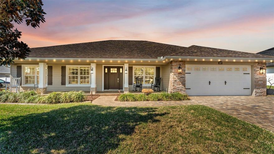 Welcome to 187 Bentley Oaks Blvd. This 3 Bedroom 3 Bathroom (with an office) Pool home is a custom built Danny Sadler Home. The home is move in ready and it could be yours to enjoy the pool and back yard BBQ's just in time for the spring and summer. This isn't your standard cookie cutter home, as it has TONS of features and upgrades. As you approach the home you will see the pavered driveway which has been extended to the side of the garage for extra parking and a beautiful front porch. Once inside you will see an open concept of Dining/Kitchen/Living room complete with Tray Ceilings and a wood accent entertainment built in which creates quite the focal point. There is wood look tile throughout the main living spaces. The Kitchen is complete with Real Wood Cabinetry, Granite Counter Tops, And Stainless appliances which have been upgraded within the last few years. There is also an additional Bar area which would make a great coffee and/or cocktail bar. The Primary Suite is complete with a beautiful accent wall, Dual Sinks, a clawfoot tub, Stand alone shower, and Large Walk In Closet With Built Ins, and as a bonus a hidden closet. Stepping Out of the Back doors you have a covered lanai, which is made for entertaining and a screened in Pool. The back yard is completely fenced in and has a privacy hedge just inside the fence to be able to enjoy your private Oasis. The is a pavered fire pit area in the back yard as well. This home was built with entertainment in mind. The home has security cameras and Indoor/outdoor speakers. Schedule your showing and start packing your bags, this house is special and you don't find ones like this every day.