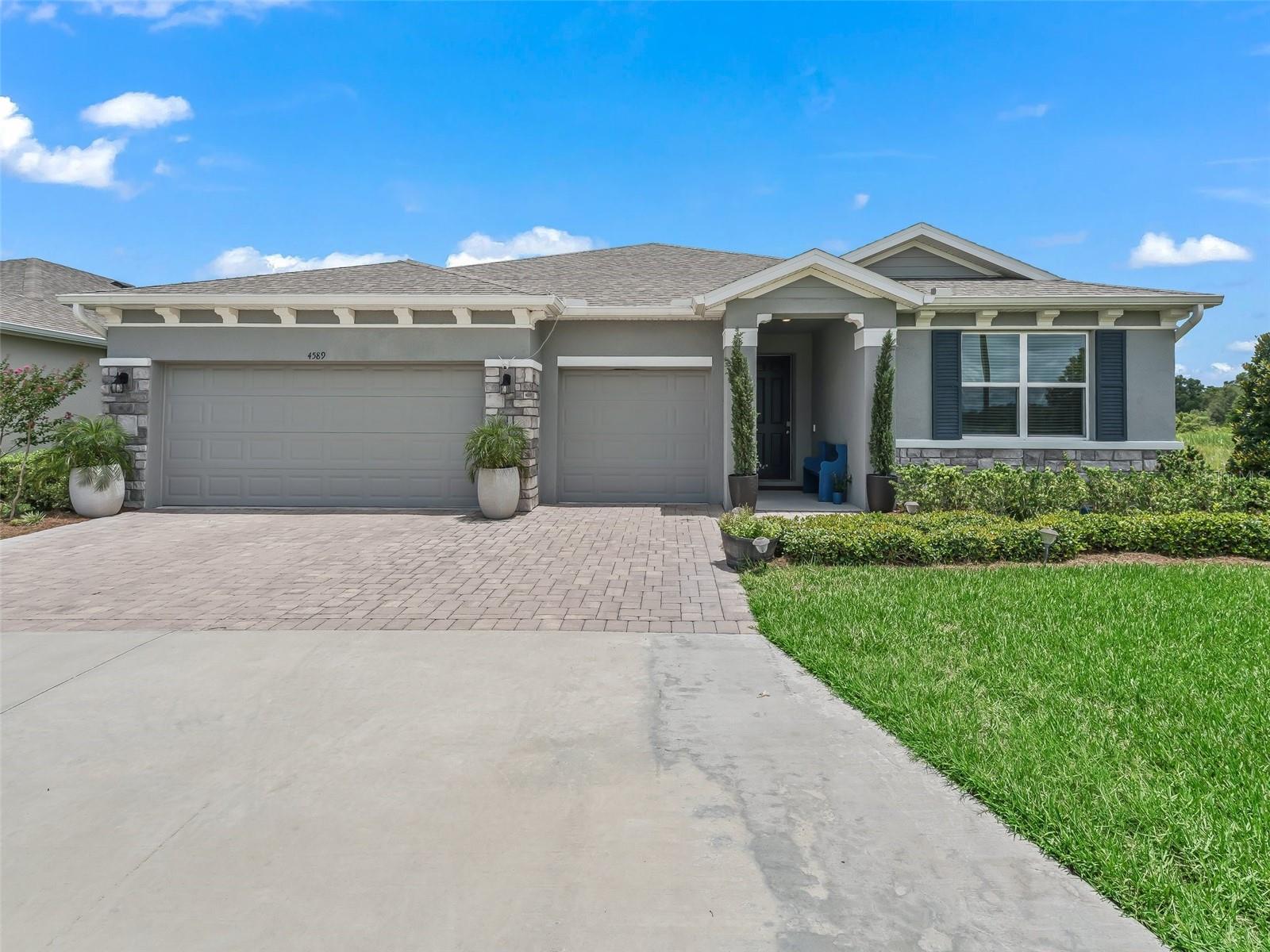 Welcome to a resort style like living!!! This is a ONE OF A KIND multi-generation model, available for lease in OCALA PRESERVE! Offered UNFURNISHED. Experience luxury, flexibility, and privacy in this stunning and spacious 2023-built home, located in the resort-style community of Ocala Preserve. Boasting 4 bedrooms, PLUS FLEXROOM, 3.5 bathrooms, a 3-car garage, and 2,836 sq ft of stylish living space, this home is thoughtfully designed for both everyday comfort and multi-generational living. The layout of this home is truly fantastic!!! Step inside to find an open-concept layout featuring a spacious great room, formal dining area, and a gourmet kitchen with a large island, stone countertops, stainless steel appliances, and a bright dinette that flows seamlessly to the extended patio. The outdoor living space has been beautifully upgraded with an oversized, covered lanai, beautiful landscaping, and peaceful views of the retention pond—creating the perfect backdrop for entertaining or quiet evenings at home. Plus, enjoy maximum privacy with only one neighboring home to your right. One of the standout features of this home is the multi-generational suite, complete living area, bedroom, walk-in closet, full bathroom, and a kitchenette with refrigerator, sink, and cabinetry—ideal for in-laws, guests, or an independent workspace. The master suite is privately situated at the back of the home, offering tranquil backyard views, a spacious ensuite bathroom, and a walk-in closet. At the front of the home there are two additional bedrooms sharing a Jack-and-Jill bathroom, perfect for family or guests, while a convenient half bath and full laundry room add to the home’s functionality. Additional highlights include smart home features, tile flooring in main living areas, and all-concrete block construction for durability and energy efficiency. Located in Ocala Preserve—just minutes from the World Equestrian Center and I-75—you’ll enjoy world-class amenities including golf, pickleball and tennis courts, resort and lap pools, a full fitness center, walking trails, spa services, and The Salted Brick restaurant and bar.