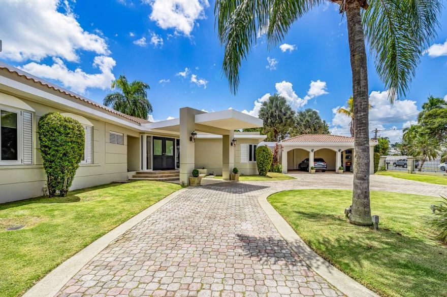 Presenting an Iconic Masterpiece in Santa Maria: San Juan's Premier Luxury Community!
 
Built in the 1990s and meticulously renovated in both 2004 and 2017, this exceptional residence stands as a testament to timeless Mediterranean design. Spanning 5,353 square feet of interior space, complemented by 2,210 square feet of outdoor living, this home offers a grand total of 7,563 square feet of luxury living.
 
Upon entering, you'll be greeted by timeless marble floors and high ceilings that display opulence throughout this one level estate. Every detail has been carefully considered to ensure the utmost in comfortable living.

The main bedroom wing encompasses four generously proportioned bedrooms, with the potential to convert one area into a fifth bedroom, making this home perfect for families of all sizes. The principal bedroom and its accompanying bathroom enjoy full patio vistas that invite the lush greenery of the outdoors inside.

There are a total of 7.5 bathrooms, ensuring convenience and privacy for all. Additional highlights include a service room and a well-appointed office, as well as a 3-car garage with ample storage space. There is also a multiple-use room, that can be either a gym, another family room, or a guest bedroom.

Sitting on an expansive lot of 4,139 square meters, this property offers unparalleled privacy. The backyard is an entertainer's dream with a picturesque setting. Enjoy a refreshing dip in the pool year-round and take advantage of the vast green yard to create your own sports and recreational courts.

Located in a prime spot within Orquidea Street, this property boasts a predominantly flat lot—hard to find in Santa Maria. It comes fully equipped and with a power generator. 

Santa Maria is a gated community with 24/7 surveillance, providing a safe and family-oriented environment. It is ideally situated close to the finest schools, businesses, restaurants, and nightlife in San Juan.

Don't miss your chance to tour this unique gem, available for sale for the first time. Contact us today to schedule your private viewing.