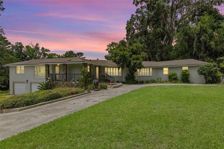 Make sure to check out the Virtual Tour for a 3D Model w/ Walkthrough, Floor Plan w/ Measurements, Video, & more! If you’ve ever dreamed of living in a lakeside retreat with a tennis court, a gazebo, storage shed/carport and a dash of old-school charm, this 1951 classic on “Doctors Row” might just be your prescription for happiness! This two-story beauty offers a new flat roof over sunroom 2023, 3,075 sqft of heated and cooled living space on a sprawling 3.41-acre lot. Featuring 4 bedrooms with TWO Master Suites, a bonus room/office/den, 3 full baths and 2 half-baths PLUS a living room, sun room, formal dining, and TONS of storage space! Laundry? No problem! This home offers you a choice of upstairs/inside laundry hookup or downstairs/garage laundry hookup! (Maybe choose both because who wouldn't want to get all of the laundry done WAY faster!?) The grand living room features beautiful hardwood floors that flow throughout most of the home, a wood-burning fireplace, rich paneling, crown molding, wainscoting, plantation shutters, and soaring 10-foot ceilings. The sunroom, adorned with brick accents and more plantation shutters, opens onto a large deck overlooking the back yard and the lake - perfect for morning coffee or evening relaxation.  Speaking of views, almost all the windows in the home have been replaced by Anderson Windows in 2023. The kitchen is equipped with stainless steel appliances, a commercial-grade gas range and hood, and a trash compactor ready for your culinary adventures. The expansive 18x20 main master suite boasts a private balcony overlooking Lake Montgomery, offering serene water views to start and end your day. The circular driveway leads to a large front porch (equipped with leaf guard gutters), inviting you to sit and stay awhile. Out back, enjoy the gazebo, dock/fishing platform, and a tennis court that might just inspire your inner Serena or Roger. The large rear deck is ideal for entertaining, barbecues, or simply soaking in the natural beauty that surrounds you. Located on the affectionately dubbed “Doctors Row,” this home is nestled in a community known for its charm and character. You're just minutes away from downtown Lake City, where you can explore the Lake City-Columbia County Historical Museum, enjoy events at The Blanche, or dine at local favorites like Halpatter Brewing Co. Outdoor enthusiasts will appreciate the proximity to Alligator Lake Recreation Area, offering trails, fishing, and birdwatching opportunities. This Lake City gem combines classic elegance with modern amenities, all set on a picturesque lakeside lot. Whether you're hosting gatherings, enjoying outdoor activities, or simply relaxing in your sunroom, this home offers a lifestyle that's both comfortable and captivating.
