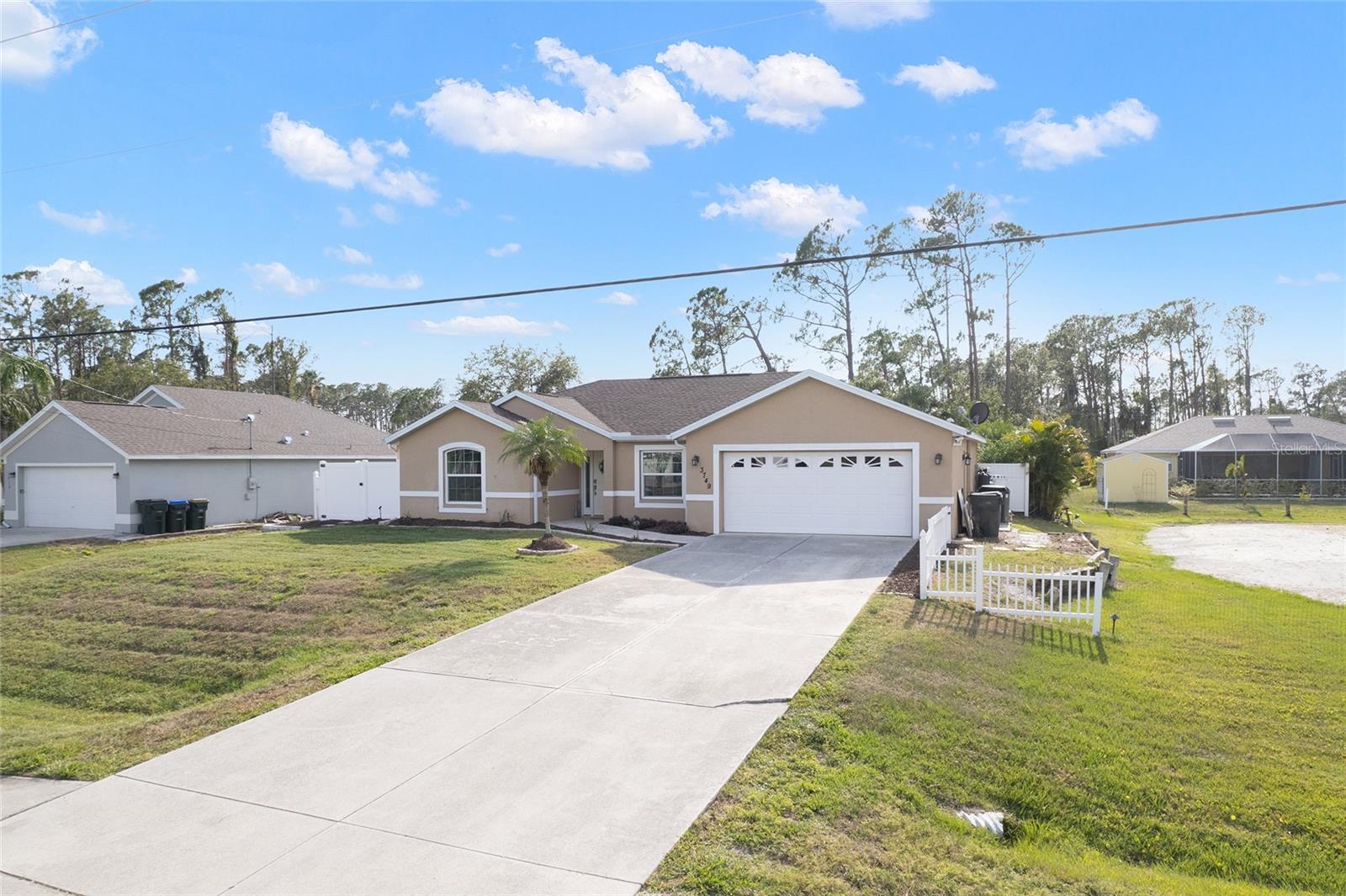 Come take a look at this fantastic, completely renovated & updated, pool home on a double lot, close to everything. This smart home, wired for sound and lighting, is your oasis in the middle of it all. Come in thru the front door to a wide open great room & kitchen setting, high-end tile flooring throughout, granite counters with upgraded cabinets in a well-planned and nicely apportioned kitchen, with higher end, newer appliances. All of the big ticket items are accounted for: 2021 roof, 2023 A.C., newer water heater, PGT impact windows, 2021 well & softener equipment all mean no worries in the near future for major expenses. The extra lot has been cleared, filled and is ready for whatever you can imagine. The pool with expanded lanai, (ready for your outdoor kitchen!) and amazing lighting will make you want to stay outside all the time: and you can because you also have a hot-tub to enjoy! The entire home and lanai are wired for sound with HTD sound: all rooms have speakers, the living room has surround sound and it is all controlled from a central I-pad that is smartly mounted in the wall by the kitchen. No worries however if you want to listen to something else in your room; each room is set up with individual touch-pad sound controls discreetly set into the walls. The garage is spacious and well laid out with a generous laundry area offering an over-sized utility sink and higher-end washer and dryer stacked combo units. The central vacuum system makes for easy cleanup, regardless of the mess. Close to schools and shopping this home offers it all. City water is available at the street as well if the buyer wants to connect. Come see this before its gone! (saltwater fish tank & equipment are not included in sale and seller will remove before closing) (Lanai furniture & fire-pit are not included; some furnishings are negotiable).
