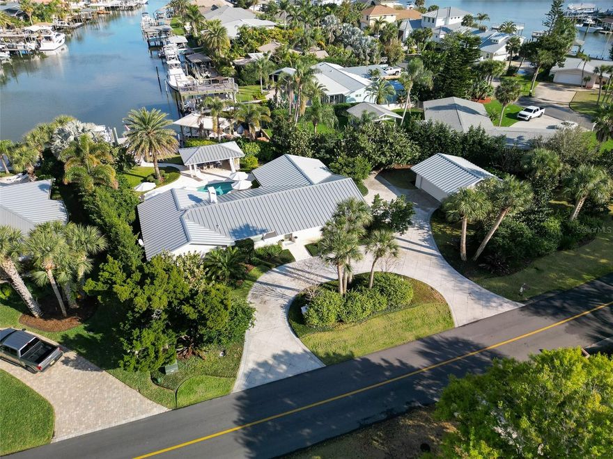 Deepwater 3 bdrm 2 bath pool home with 4 car garage, in highly sought after Venezia neighborhood.  Upgraded with great thought and care throughout.  There’s a fabulous coral fireplace, raised vaulted ceilings in the living room and kitchen, quartz and marble counters, custom interior pine doors, and engineered pine floors.  Miele refrigerator/freezer and dishwasher.   Both the range and microwave are convection.  Perlick wine refrigerator.  The office has a closet and can easily be a 4th bedroom.  The salt pool is surrounded by coral patios and professionally designed landscape and hardscape.   The dock has a 12,000 lb lift plus floating dock for ease in launching kayaks and paddleboards.  Clean your fish at the dock and grill under the dockside cabana with summer kitchen.  The green egg and grill stay along with most of the outdoor furniture.  Wash off your day on the boat and beach in the outside shower. The lush landscaping affords amazing privacy on all sides! Reclaimed water for the sprinkler system.  There’s both an attached and detached 2 car garage affording space for a workshop, golf cart and other toys. There’s a whole-house generator with 500 gallon tank.  This home and surrounding property was renovated between 2015 and now with most work both inside and out completed by local, long-time Volusia County craftsmen.  All structures are concrete block with Hardie board soffits, fascia and columns.  All windows, doors and garage doors are impact.  New standing-seam metal roofs on both buildings 2022. $2,490,000.