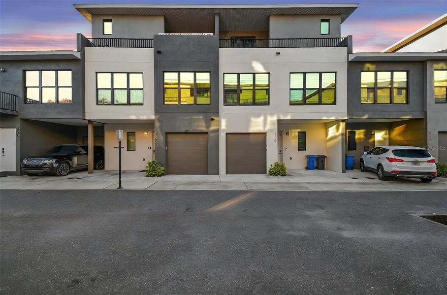 Welcome to modern Tampa living in Palm Ranches, where this thoughtfully designed 3-story townhome blends clean architectural lines with everyday functionality- offering a flexible layout ideal for professionals, families, or investors seeking a low-maintenance lifestyle in a prime location. This all-block construction chic contemporary townhome has been outfitted with smart home tech including HIVE integrated and mobile app operated automatic window shades, temperature control, cameras/security, and wired for an upgraded speaker system throughout. The main living level showcases an open-concept floor plan filled with natural light, 9.5ft high ceilings, and contemporary finishes throughout. The kitchen anchors the space with sleek cabinetry, white quartz countertops, stainless steel appliances, and ample prep and storage space, perfect for both entertaining and daily living. The living and dining areas flow seamlessly, creating a comfortable yet elevated atmosphere, filled with natural light from large windows and French doors opening to a quiet backyard retreat. A stylish contemporary staircase is outfitted with an elegant designer light fixture cascading from the upper level. The 2nd level includes the primary suite which serves as a private retreat with a spacious walk-in closet and an en-suite bath featuring modern finishes, dual sink vanity, and walk-in shower. Two additional bedrooms provide flexibility for guests, a home office, or family needs, with the laundry closet conveniently located on the same level. The top floor adds valuable bonus space as a fourth bedroom with a full bath, or large second living space/loft, along with access to balconies on each side. The front balcony includes a spacious private covered terrace- ideal for outdoor dining, relaxing evenings, or entertaining under the Tampa sky. The top floor also features a special bonus space currently designed as a private cigar and whiskey room, complete with a glass-enclosed, temperature and humidity-controlled storage area ideal for your personal cigar, wine, and/or spirit collection- offering a distinctive retreat that can also easily be reimagined as a lounge, office, or creative space. This luxurious property has the OPTION of also being purchased FULLY FURNISHED as shown (excluding select personal items) offering an easy turnkey option for buyers seeking convenience or an investment-ready setup. Additional highlights include an attached garage, contemporary construction, luxury vinyl flooring throughout, and a well-maintained community with exterior maintenance included. Centrally located just minutes from I-275, Tampa International Airport, Raymond James Stadium, International Plaza, Midtown, Downtown Tampa, Dale Mabry, and major highways, this home offers exceptional access to everything the city has to offer.

A move-in-ready opportunity to enjoy modern design, convenience, low HOA, and the urban Florida lifestyle in one of Tampa’s most connected locations.