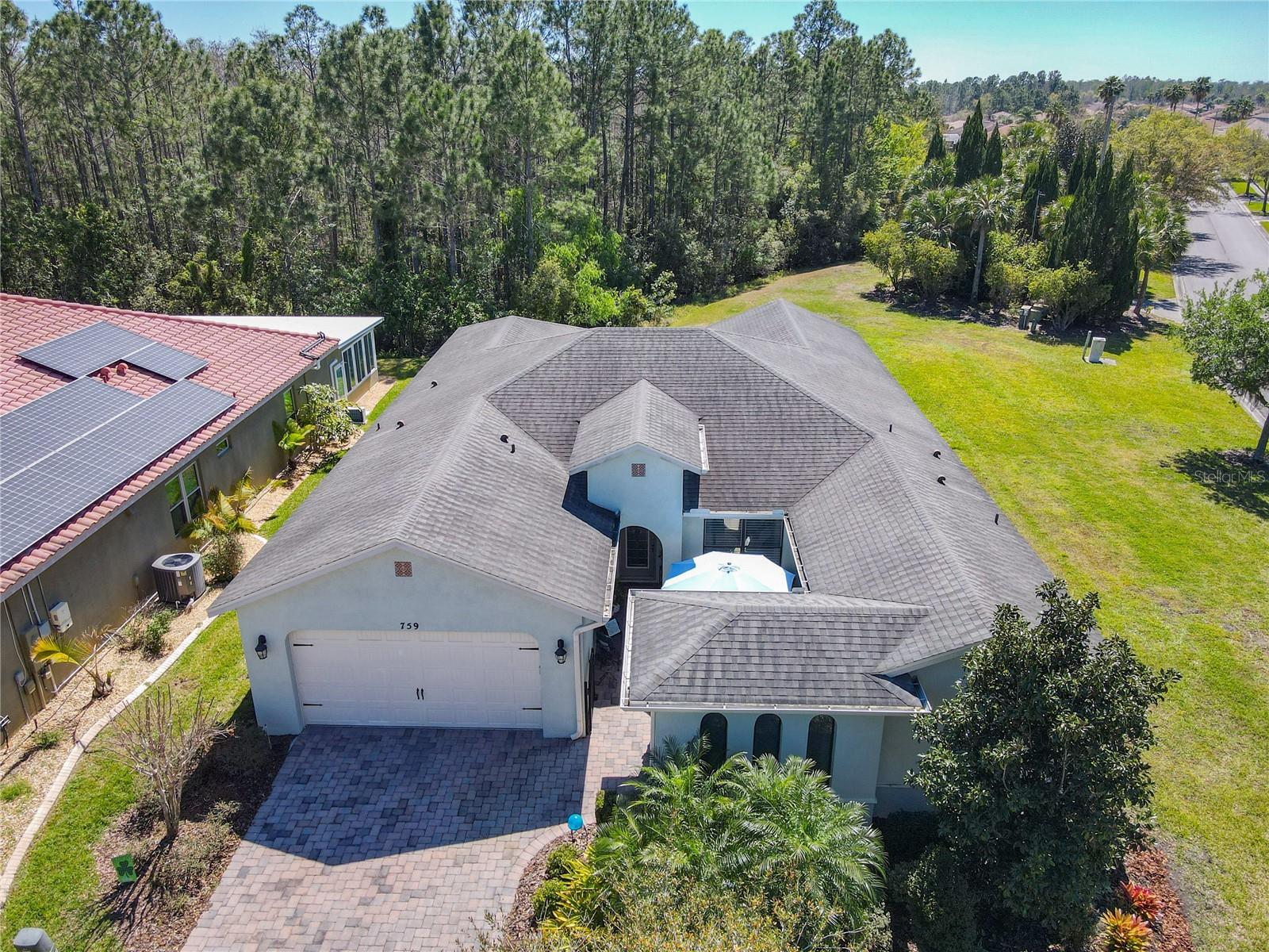 THE SELLERS ARE VERY MOTIVATED TO SELL with a HUGE LIST PRICE DEDUCTION!! Welcome to this MOVE-IN READY NAPLES Model on a larger CORNER LOT with a CONSERVATION VIEW. This awesome HOME is one of the largest homes in Solivita, and a delightful place to entertain. Some FURNITURE is included in the sale. (SEE Attachment). Begin your journey in the PRIVATE Courtyard; an outdoor space for a water feature, plants, or just relaxing. Enter through the LEADED GLASS front door, and check out 18 inch CERAMIC TILE in the kitchen, foyer, great room, lanai, dining room, laundry room, halls, and all bathrooms. Appreciate the CUSTOM ILLUSION BLINDS throughout this GORGEOUS home. Many UPGRADES to include the following: The GREAT ROOM has a Minka Fan, CUSTOM drapes, and vaulted ceiling. The DINING ROOM has a BEAUTIFUL CHANDELIER, CROWN molding, and custom DRAPES. The KITCHEN includes a BREAKFAST area, CORIAN counters, Stainless Steel appliances to include a 2024 LG four door Smart Refrigerator with an extended warranty, 24 FULL extension PULL OUT drawers with CUSTOM drawer pulls and handles, an ISLAND/BAR, RECESSED Pendant Lighting, back splash, under CABINET LIGHTS, a deep double SINK and faucets, and a large WALK-IN PANTRY. Enjoy the BUTLER pantry with a backsplash and CORIAN counters. The PRIMARY BEDROOM has LUXURY Vinyl Plank Flooring, a HUGE Walk-In closet that was customized designed with drawers, long and short hanging areas for your clothes, a bench and over head storage, and a DIMMABLE light. PRIMARY BATHROOM has a walk-in shower with a seat, custom hand held SHOWER HEAD, DUAL SINKS, wall to wall cabinets with full extension pull-outs, and CUSTOM LIGHTS above mirrors. The GUEST SUITE has double doors opening, and an area for an OFFICE with shelves. The GUEST SUITE BATHROOM has a walk-in shower with a handheld shower head, custom hardware on the CABINETS, and five PULL OUT drawers. The LAUNDRY ROOM has 42" CABINETS, and a stainless steel SINK. The LANAI is enclosed with two 16' SLIDING DOORS, hard top ROOF, two ceiling fans, woven custom blinds that beautiful VIEW. The GARAGE has a REFRIGERATOR, CUSTOM made shelving on both sides, overhead shelving, and an EPOXY garage floor. MAKE THIS HOME YOURS TODAY!! Solivita is an active adult 55+ community located in Kissimmee, Florida. It is approximately 50 minutes from Disney World and the Orlando International Airport. Enjoy your active years in this piece of paradise. Solivita's amenities include: - a manicured SOFTBALL diamond & field - 36 holes of CHAMPIONSHIP GOLF that can be played by joining the Stonegate Golf Club or paying as you go - 2 STATE of the Art AMENITY centers with updated exercise equipment, yoga studio and meeting rooms-3 restaurants - 14 HEATED POOLS - 17 PICKLEBALL courts -4 Bocce Ball Courts-3 Horseshoe Pits- four SHUFFLEBOARD Courts-miles of bike paths-TOT Lot Playground-2 DOG PARKS (Small & Large Dogs) - over 300 resident clubs. The HOA PROVIDES SECURITY with gate guards-maintains the LANDSCAPING AND IRRIGATION systems in the common areas as well as individual homes-maintain the roads-allows AUTOMATED GATE ACCESS for residents via license plate readers. ***Poinciana Lakes Plaza is a MAJOR NEW SHOPPING CENTER that opened directly across from Solivita Main Gate in Summer of 2024. It features Sprouts Grocery, TJ Max, Ross, Burlington, Rack Room Shoes, 5 Below, Ultra, Outback, First Watch, 5 Guys, Urgent Care, Dentist, TD Bank, Petco, and Hair Cuttery, PLUS MORE TO COME.