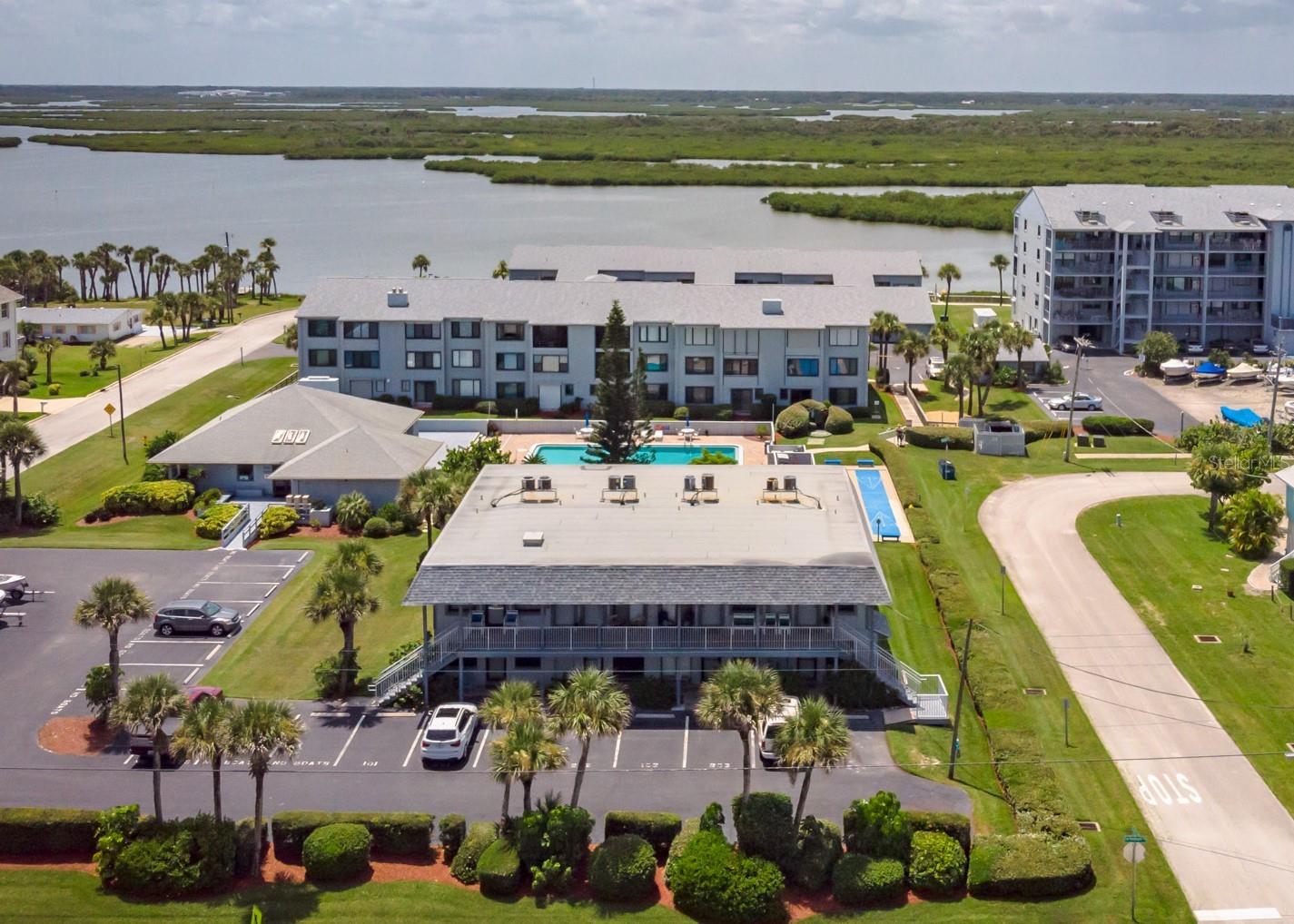 Enjoy the best of both worlds, ocean and river… This 2 bedroom / 2 bathroom condo will check all of the boxes. Turnkey... furnished and ready for your getaway. Quick walk East to the no-drive beach, short stroll West to the river, a few blocks South to World Famous JB's Fish Camp and about a mile from the entrance to the Canaveral National Seashore gates… Watch space launches from your kitchen window! Community amenities include a pristine pool, well equipped clubhouse, outdoor grill, private boat ramp, boat docks, fishing dock, shuffleboard, kayak/sup storage with launch area on the river. The community is located next to a county park with tennis, pickleball, basketball, volleyball, playground and dock overlooking the manatee cove. Cable, internet, water, trash, included w/ hoa! Impact windows, new doors, remodeled master bath, large screened/covered back patio. Use as a primary residence, vacation rental or your winter retreat. Currently zoned for weekly rentals. The possibilities are endless. Just bring your toothbrush and let your NSB lifestyle begin
