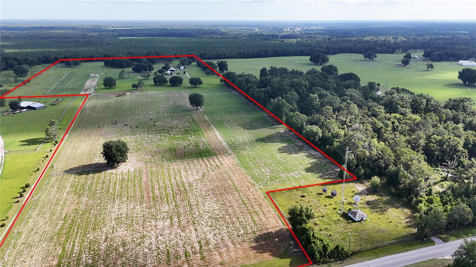 Developable Tract! Discover this exceptional 48-acre working cattle farm just outside the historic town of Fort White in Columbia County, Florida, and only 1.2 miles from the charming town center. With paved road frontage along Wilson Springs Road and graded road access on Jordan Street, this property is perfect for agricultural pursuits. In addition, this parcel has a registered division allowing for 5 parcels without additional requirements. The farm includes a spacious pole barn, workshop and various accessory structures for livestock management and to meet the general for a small farm lifestyle. The highlight is a 2018 singlewide manufactured home, beautifully appointed with high-end finishes. Enjoy easy access to the picturesque Ichetucknee, Santa Fe, and Suwannee rivers, making it ideal for outdoor enthusiasts seeking a serene country lifestyle. Act fast and this property can be offered turn- key with a herd of premium Dexter cattle and all the farm equipment needed to manage your operation.