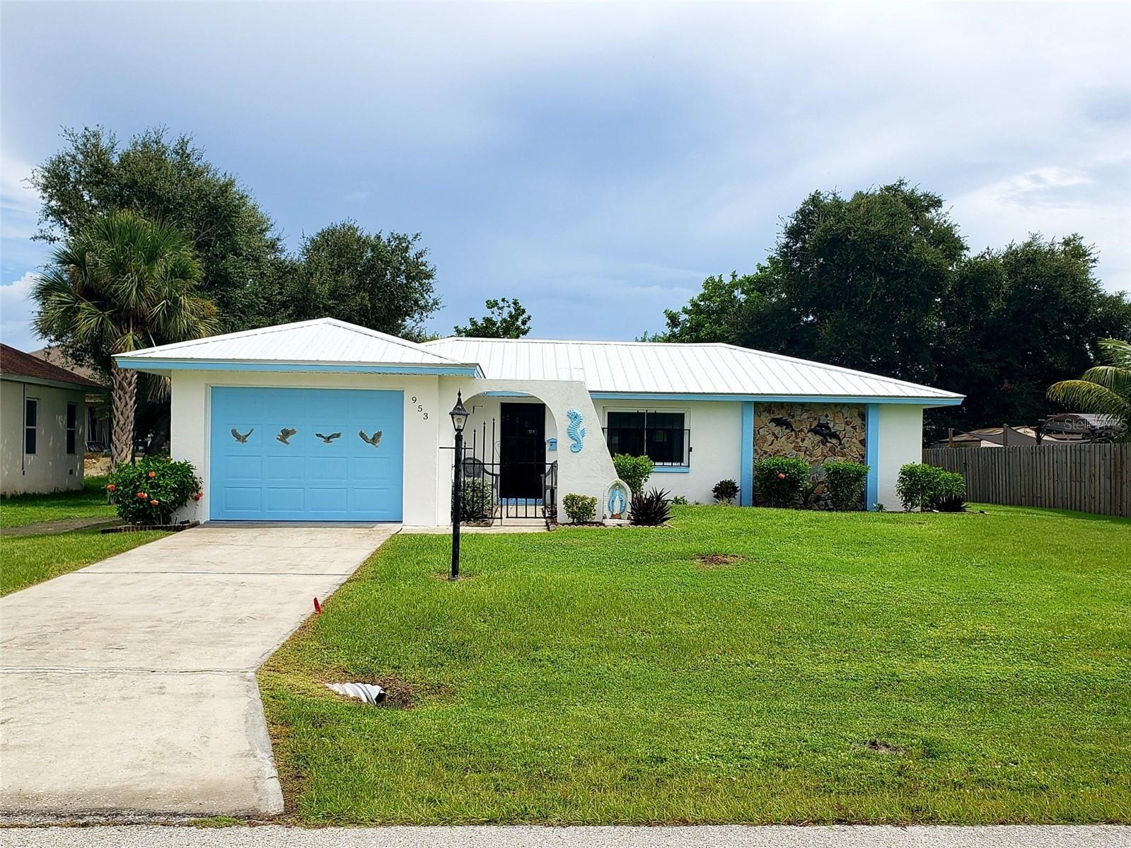 Welcome to easy Florida living! This 2-bed, 2-bath home sits in the heart of Port Charlotte, close to everything yet backed by a peaceful wooded lot for extra privacy. Inside you’ll find a split bedroom layout and a sunny Florida room perfect for relaxing. The yard is beautifully landscaped, and there are two big workshop sheds with power—ideal for projects or storage. Major updates are already done: metal roof with a transferable 30-year warranty installed in 2023, hurricane-impact windows installed in 2023, newer A/C (2019) which is professionally serviced twice a year, and an upgraded electrical panel. The kitchen features sleek quartz counters, plus a water softener for great-tasting water. All utilities are underground for a clean look and fewer storm worries. An outdoor utility sink and shower make it easy to rinse off after gardening, and best of all, no flood zone. Don’t miss this opportunity, schedule your showing today!