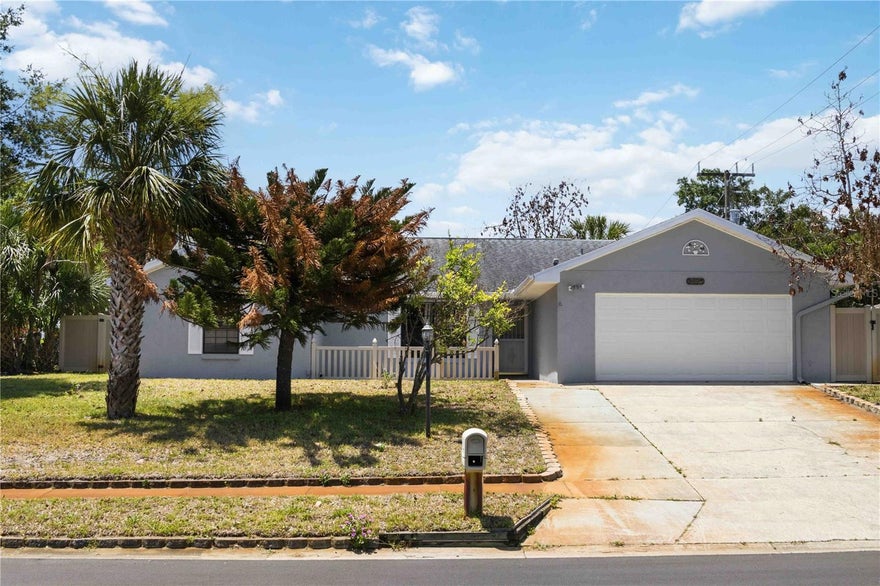 One or more photo(s) has been virtually staged. Welcome to this beautifully maintained 3-bedroom, 2-bathroom single-family home offering 1,670 square feet of comfortable living space in Titusville. With major updates already completed, including a new AC in 2024, newer roof in 2017, and water heater in 2025, this home is move-in ready and designed for everyday living and entertaining alike. Upon entering, you are welcomed by a dining area that flows seamlessly into the family room, creating an inviting open-concept feel. At the heart of the home, an additional living room showcases vaulted ceilings, a stunning stone wood-burning fireplace, and direct access to the kitchen, where solid wood cabinetry immediately captures your attention. The kitchen features an ample amount of cabinet storage, generous counter space, and a center island perfect for meal prep, gathering, and everyday functionality. Sliding glass doors lead into the fully enclosed Florida room, offering the perfect space to relax year-round while overlooking the spacious fenced backyard. The split-bedroom floorplan provides added privacy, with the primary suite featuring an en suite bathroom complete with dual sinks and a walk-in shower. The secondary bedrooms offer flexibility for guests, hobbies, or a home office. Conveniently located near restaurants, grocery stores, golf courses, and everyday shopping, this home also provides easy access to I-95 and is just minutes from the beautiful Space Coast beaches and waterfront attractions. Mortgage savings may be available for buyers of this listing.