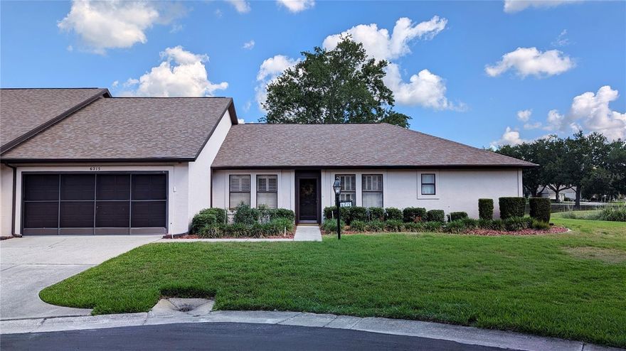Experience the best of Florida living in this beautifully updated 3-bedroom, 2-bathroom villa located in the sought-after Pinehurst Village of Meadowcrest. This home occupies an exceptional lot, offering an incredible amount of open space to the side and rear that provides a rare sense of privacy and serene views from windows on all sides. The spacious interior features a split-plan layout with vaulted ceilings, gorgeous hardwood floors, a formal dining area, and a versatile den that makes for an ideal home office or sitting room. Both the kitchen and bathrooms have been tastefully updated, including granite countertops and rich wood cabinetry in the kitchen.  The large 2-car garage provides ample storage. Major mechanical updates offer peace of mind, including a new HVAC in 2021 and an upgraded 200-amp electric panel from 2020. The monthly $424.00 fee covers exterior maintenance—including painting and roof replacement—as well as lawn care and trash removal. Residents enjoy premier community amenities including two swimming pools (one heated), a clubhouse with a library and billiards, tennis and pickleball courts, and scenic walking trails that meander through the lush, nature-filled grounds.