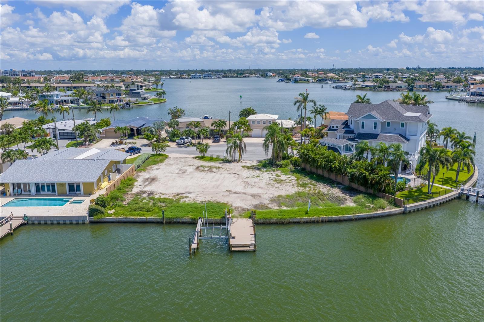 Your waterfront vision starts here! Imagine designing your dream home on one of Treasure Island's most exceptional waterfront properties. Welcome to 15 Marina Terrace - a 1/3 acre, oversized lot in the sought-after Paradise Island neighborhood, perfectly positioned for luxury living. Boastling 150' of seawall, composite dock, and a 10,000 lb. boat lift, this property offers direct, bridge-free access to the Gulf of America for endless boating, fishing, and water adventures. The expansive footprint (averaging 134' x 119') provides a rare canvas for a custom home with resort-style amenities, lush landscaping, and generous outdoor living areas. Enjoy breathtaking westerly water views and spectacular sunsets right from your backyard. The previous structure and pool have been removed, giving you a fresh start for your vision. All of this, just minutes from award-winning beaches, shopping and vibrant restaurants. This is more than just a well-situated lot, it's an invitation to live the ultimate Florida waterfront lifestyle.