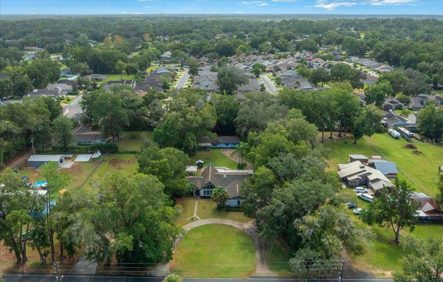 Discover a rare opportunity to own a beautifully unique and character-filled 5-bedroom, 4-bathroom pool home located right in town—yet offering the peaceful privacy of country living. Nestled on a lush property, this home includes a 1,128 square foot detached in-law suite with its own entrance—perfect for guests, multigenerational living, or income potential as a fully functional Airbnb. Inside the main house, you’ll be greeted by soaring cathedral ceilings accented with gorgeous wooden beams, giving the space warmth and charm. The oversized Jacuzzi tub in the spacious primary suite is your personal retreat, perfect for relaxing after a long day. Outdoors, the property is a gardener’s paradise with several garden spaces, a space for a serene pond, and a bounty of fruit-bearing plants including muscadine grapes, avocados, bananas, dragon fruit, and lemon trees. Enjoy your morning coffee surrounded by the beauty of nature, all while living minutes from town amenities. Additional highlights are a private well (no water bill), a two-car garage, an RV hookup, outdoor shower, a circular driveway for easy access and ample parking, and a home filled with personality, character, and special touches throughout. This isn’t just a home—it’s a lifestyle. Whether you’re looking for space to grow, room to entertain, or the opportunity to host guests or short-term rentals, this property has it all. Schedule your private tour today and experience the magic for yourself!