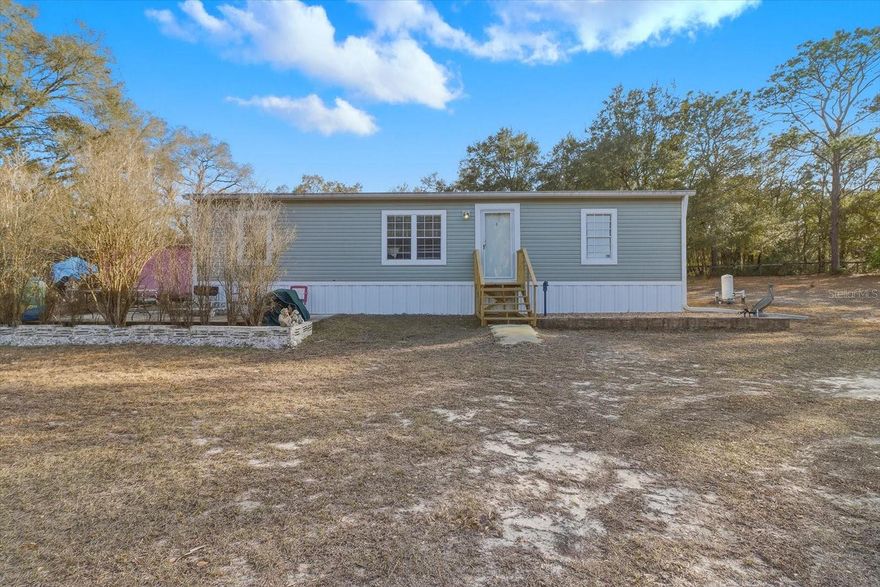 Enjoy peaceful country living in this 2–3-bedroom mobile home located in the desirable Mini Farms of Dunnellon, Florida. Situated on 2.52 fully fenced acres, this property offers privacy, space, and versatility. The land features two utility sheds (10x10 and 10x16) for storage or projects, along with a wonderful assortment of fruit trees to enjoy right from your own yard. Nestled in a quiet, serene area, this property is for those seeking room to roam, garden, or simply relax and enjoy nature.