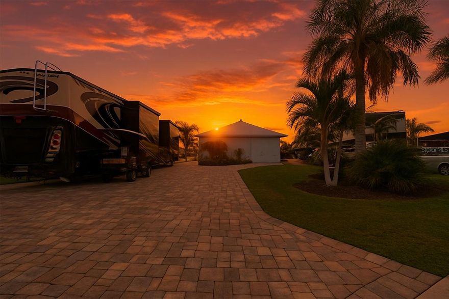 Lot 93 – Custom Casita with Designer Finishes & Stunning Water Views
Experience refined living at Lot 93 in Thornton Creek Motorcoach Resort—an elegantly crafted custom casita that blends luxury, functionality, and breathtaking waterfront views. Every detail of this home has been intentionally designed to create a seamless flow between comfort and style.
The heart of the casita is the main living area, featuring vaulted ceilings, a gas fireplace, and open access to the gourmet kitchen. Perfect for both entertaining and everyday living, the kitchen is equipped with granite countertops, high-end KitchenAid appliances, including a six-burner gas stove, built-in oven, microwave, dishwasher, and full-sized refrigerator. A peninsula with bar seating and a walk-in pantry enhance both practicality and visual appeal.
Double doors lead into a spacious second living area with tray ceilings, a cozy couch, mounted TV, and built-in surround sound—a flexible space that connects effortlessly to both the bedroom and bathroom. The bedroom offers a private and serene escape with custom shutters, a built-in closet, and ample space for restful living.
The bathroom was thoughtfully designed for both luxury and functionality, featuring an extended vanity with abundant storage and a glass-enclosed walk-in shower with bench seating. It also connects directly to the air-conditioned garage, which offers flexible use as a golf cart bay, office, or additional storage. A stackable washer/dryer and built-in closet system add further convenience.
Step outside into the 375 sq. ft. screened lanai, where motorized Kevlar hurricane screens allow for year-round enjoyment and smooth transitions between indoor and outdoor living. With space for both seating and a fire pit, this area flows out to a spacious pavered patio, surrounded by tropical landscaping and palm trees. The patio offers additional space for grilling, dining, and soaking in tranquil water views and the adjacent golf course’s driving range. 
From its high-end finishes to its thoughtful layout, Lot 93 is a standout property—ideal for those seeking elegance, practicality, and the full Florida lifestyle. Schedule your private showing today and experience resort living at its finest.