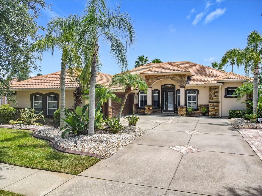 This remarkable residence showcases lavish living spaces and high-end finishes. WHOLE HOUSE GENERATOR WITH TWO PROPANE TANKS, NEW STAINLESS APPLIANCES, SUN-PRO MOTORIZED AWNINGS ON THE LANAI, EXTERIOR AND LANDSCAPE LIGHTING, DRIVEWAY WITH PAVER ACCENTS AND EXTENDED PARKING, AN OVERSIZED THREE-CAR GARAGE IS FITTED WITH A MINI-SPLIT AIR CONDITIONING UNIT AND ADDITIONAL ATTIC INSULATION. Three bedrooms plus an additional flexible room that can be utilized as an office or den, in addition to two well-appointed bathrooms. Situated on an expansive premium lot, the property offers breathtaking vistas and stunning sunrises. Upon entry, the foyer is flanked by a formal dining area and the versatile flex space. The family room, which serves as the home’s central hub, features high ceilings and smoothly transitions through triple sliding doors to the lanai. The lanai boasts an exquisite outdoor kitchen and a heated salt-water pool that gracefully overlooks a serene lake adorned with dual fountains, crafting the perfect idyllic retreat. Culinary enthusiasts will love the ample kitchen, equipped with modern stainless-steel appliances, rich wood cabinetry, and elegant granite countertops. It also includes a breakfast bar and a cozy dining nook for casual meals along with a custom wine bar situated just off the kitchen. The expansive primary suite is designed to ensure privacy and includes dual walk-in closets. The luxurious en-suite bathroom features a dual sink vanity, a soaking tub, a spacious walk-in shower, and a separate water closet. The additional bedrooms share a bathroom equipped with a tiled walk-in shower, enhanced by glass doors. A practical utility/laundry room is conveniently located near the garage, which is spacious and provides plenty of cabinetry for storage, as well as a utility sink.