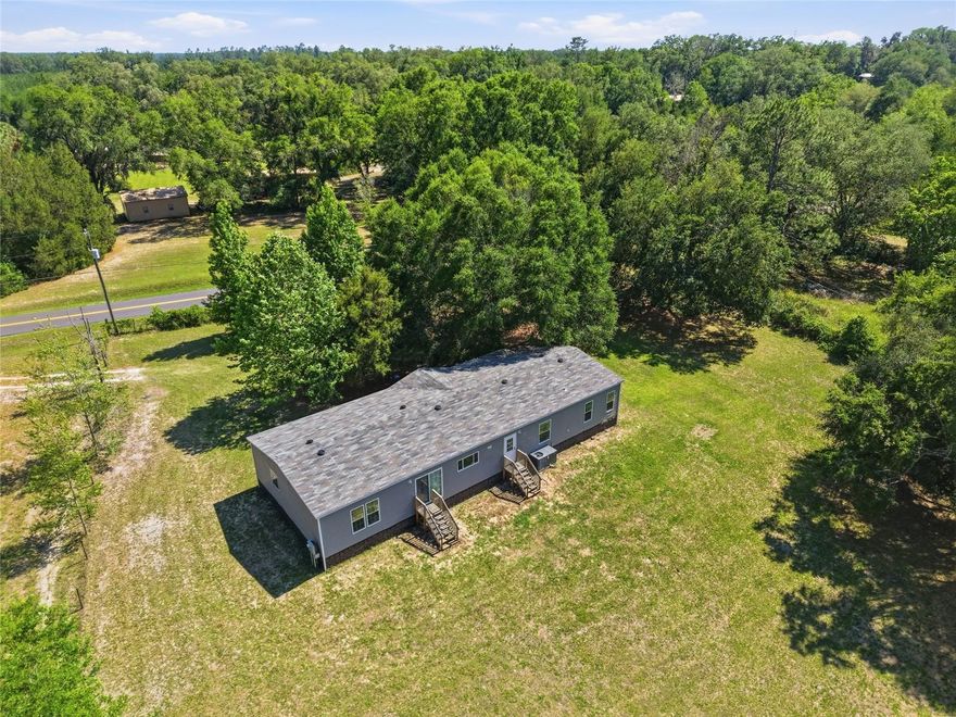 Where modern comfort meets peaceful country living in the heart of Lake City. Situated on a beautiful 1-acre lot, this stunning 2022-built home offers 5 spacious bedrooms, 3 full bathrooms, and over 2,200 square feet of thoughtfully designed living space.

Step inside to discover an open-concept layout filled with natural light, featuring a large chef-inspired kitchen with an oversized island, abundant cabinetry, and seamless flow into both the main living room and additional family room — perfect for entertaining, relaxing, or hosting gatherings.

The split-bedroom floor plan creates a private primary suite retreat, while four additional bedrooms provide flexibility for family, guests, a home office, or hobby space. Outside, enjoy the freedom and privacy of country living with room to roam, garden, or simply relax in the peaceful surroundings. Enjoy wildlife in the serenity of the beautiful natural setting while still being conveniently located just minutes from shopping, dining, entertainment, and excellent local restaurants.

Perfectly positioned close to Florida’s famous crystal-clear springs and the breathtaking Suwannee River, this property offers the ideal balance of outdoor adventure and everyday convenience. Whether you enjoy boating, kayaking, fishing, hiking, or simply soaking in North Florida’s natural beauty, this location truly has it all