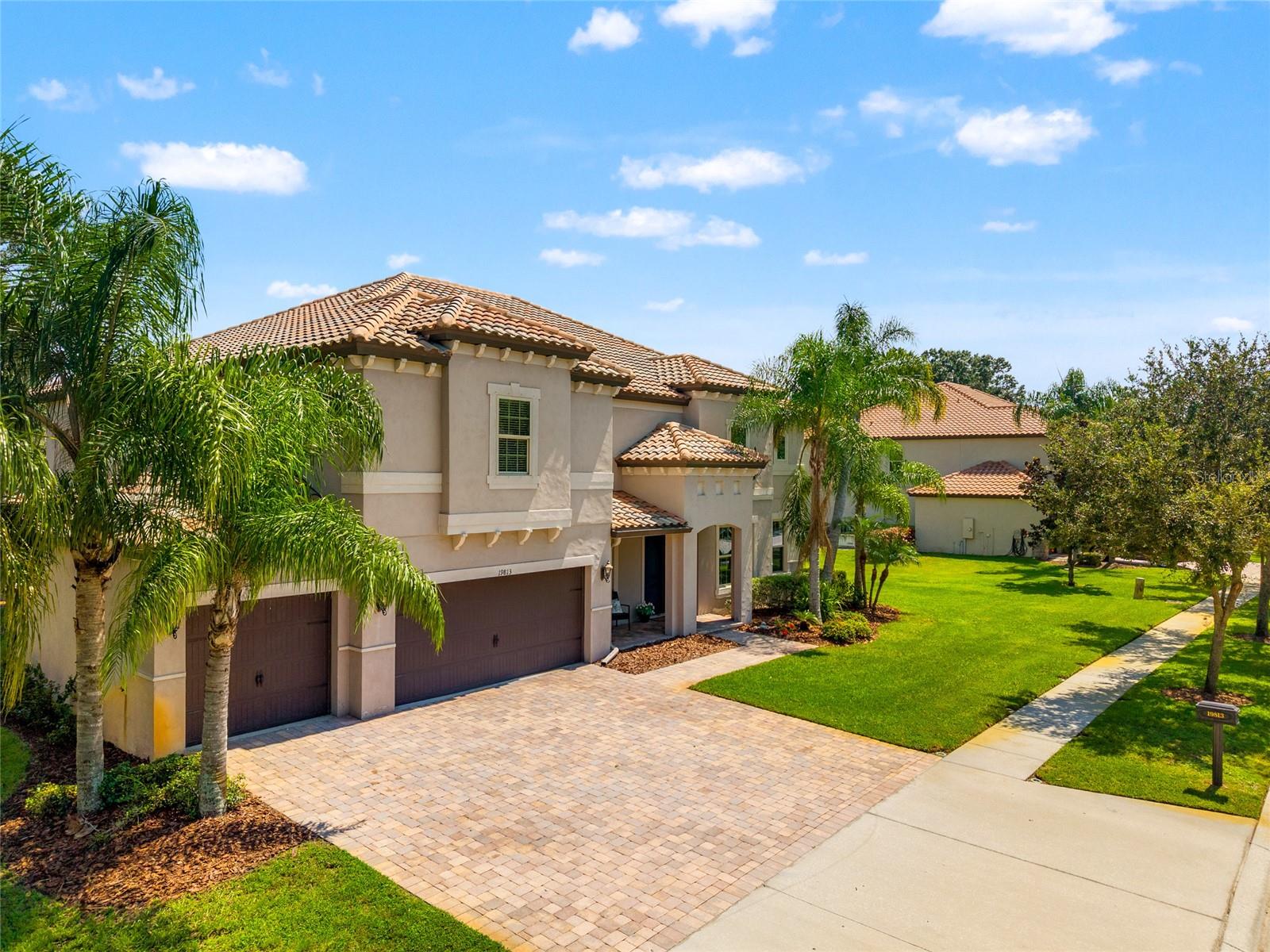 This Mediterranean-style estate in one of Lutz’s most desirable gated executive communities is the kind of home that adapts to its owner’s vision. Whether you want a space to lead and impress, to relax with family, or to entertain in style, this residence offers the versatility to meet every need and desire.
Set on a private half-acre lot surrounded by mature oaks and lush landscaping, the home makes a statement before you ever walk inside. The tile roof, paver driveway, and elegant entryway add both durability and prestige. A four-car garage, with three bays plus a tandem, offers flexibility for car enthusiasts, hobbyists, or those who simply need extra space.
Inside, the foyer opens to a grand wooden staircase and banister, with a formal dining room on one side and a professional office with an ante room on the other. From the start, it balances presence and function.
With seven bedrooms and five bathrooms, the home includes not one but two primary ensuite retreats—one on each floor. Each primary suite features split vanities, a soaking tub, and a separate shower, giving owners or guests a private sanctuary. This design is ideal for multi-generational living, visiting family, or creating a true guest experience.
The living areas flow seamlessly into spaces built for gatherings large or small. The kitchen, dining, and living spaces open directly to the screened lanai, where the pool stands as the crown feature of the home. Surrounded by pavers and thoughtfully designed for both relaxation and entertaining, the pool area offers the perfect backdrop for celebrations, quiet evenings, or weekend fun. With its screened enclosure, the space remains usable year-round, extending your lifestyle outdoors.
Beyond the pool, the oversized lot ensures privacy and a garden-like view with no neighboring home directly behind. It’s a retreat where you can recharge after a demanding day, while still being only minutes from the shops, dining, and amenities of Wesley Chapel and New Tampa.
This is more than a home. It’s a residence designed to reflect achievement while supporting every facet of modern executive life: prestige, family, business, and leisure. It is as grand as you want it to be, and as functional as you need it to be.
A video, interactive tour, and detailed floorplan are available with this listing so you can explore every angle before experiencing it in person.
Schedule your private showing today and see how this executive estate can be the foundation of your next chapter.