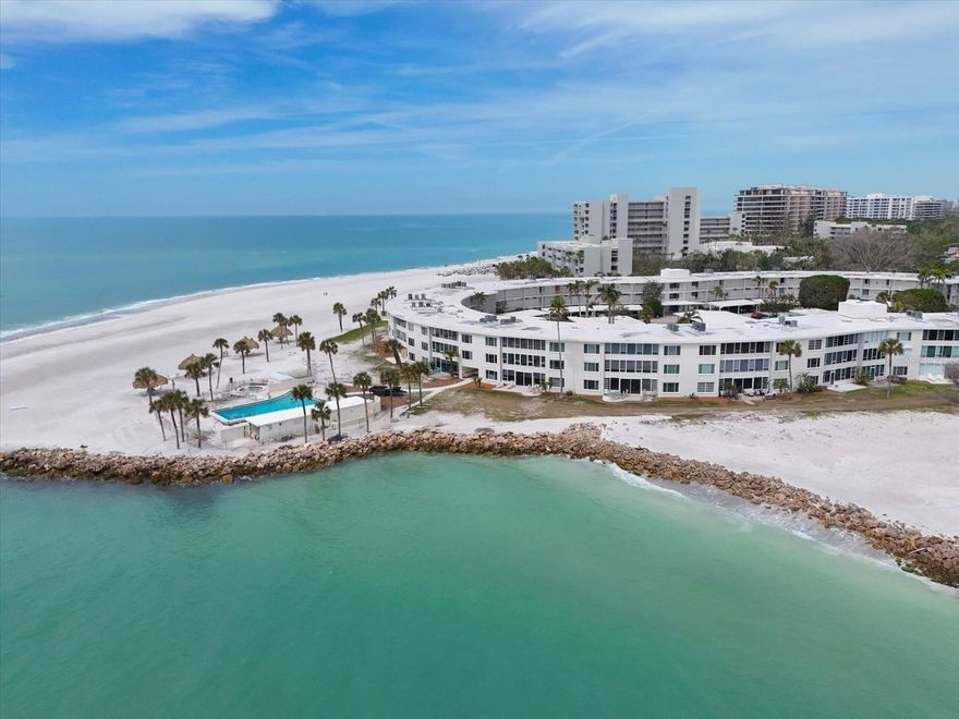 ***"This Stunning Florida Barrier Island Could Easily Pass For The Caribbean" according to Southern Living Magazine! **Make this your new home to enjoy year-round activities and gorgeous sunsets. Sands Point Condominium is a best kept secret along the crystal white sands of Longboat Key.  This community blends gorgeous mid-century architecture with the stunning location tucked away next to Longboat Key Club. Sands Point offers everything you need to relax and unwind under the Florida sun and all the amenities you could ask for including a private marina. A quick ride across Longboat Pass draw Bridge to this home on Longboat key will change your life. Suddenly, your worries will seem far away and the turquoise waters will mesmerize you. Whether you are a vacationer or full- time resident, you will find this New Pass location one of the best on the island encompassing stunning sunset views. This two bedroom unit is filled with sunlight and has had extensive renovations/remodel (2023) throughout.  The beautiful luxury flooring and tall baseboards extend throughout the entire unit. The expansive combination living/dining spaces offer room for large groups or to allow for separate seating areas; all without giving up glorious sunny views.  The gorgeous kitchen offers stainless steel Samsung appliances including a French door refrigerator, range and microwave.  The double stainless steel sink is a plus for those who love to cook.  Beautiful stone countertops top fresh white cabinetry with soft-close doors and drawers.  A generous pantry holds all the supplies you need for cooking and entertaining.  Dual sides cabinetry forms the breakfast bar offering even more storage.  The interior laundry room has GE Insignia washer and dryer and add cabinetry and shelving for storage.  Updated baths with new cabinetry and countertops.  The Primary bedroom is huge and has a wall of windows; this bright space has ample room for a desk and has two closets. The primary suite and the large great room space have stunning views of the Marina. Mid-century charm exudes from the social room gathering space with terrazzo floors and complementing furnishings is a fun space to gather and entertain having a kitchen and library. There is onsite management housed in this building as well.    A short walk takes you to the stunning beach-exactly what you come here for!  Expansive white sand beach area wraps around the complex.  Palapas, beach chairs and a newly renovated pool area over looks New Pass.  Watch the dolphins and enjoy spectacular sunsets.  The marina complex offers boat slips on a first come/first serve basis and offers a kayak launch, fishing pier, storage and bicycle storage areas.   HVAC new in 2020. The condo offers an assigned covered parking spot right in front of the unit and a separate assigned storage unit.   St Armands Circle, with a variety of restaurants and shops is a short drive away.  Come experience easy access to downtown Sarasota and its cultural and entertainment venues.  Visit new luxury resorts and beachfront dining. Nature abounds in the area. Kayak right outside your door. Golf at many of the nearby courses.  You must see this home to fully appreciate the charm, history and expansive coveted location on the beach of Sands Point.  Don't fight the crowds and traffic to enjoy the beach; you are here!!!  AMAZING LOCATION near St Armand's Circle, downtown Sarasota and all of the white sand gulf beaches.   Own a piece of paradise today!