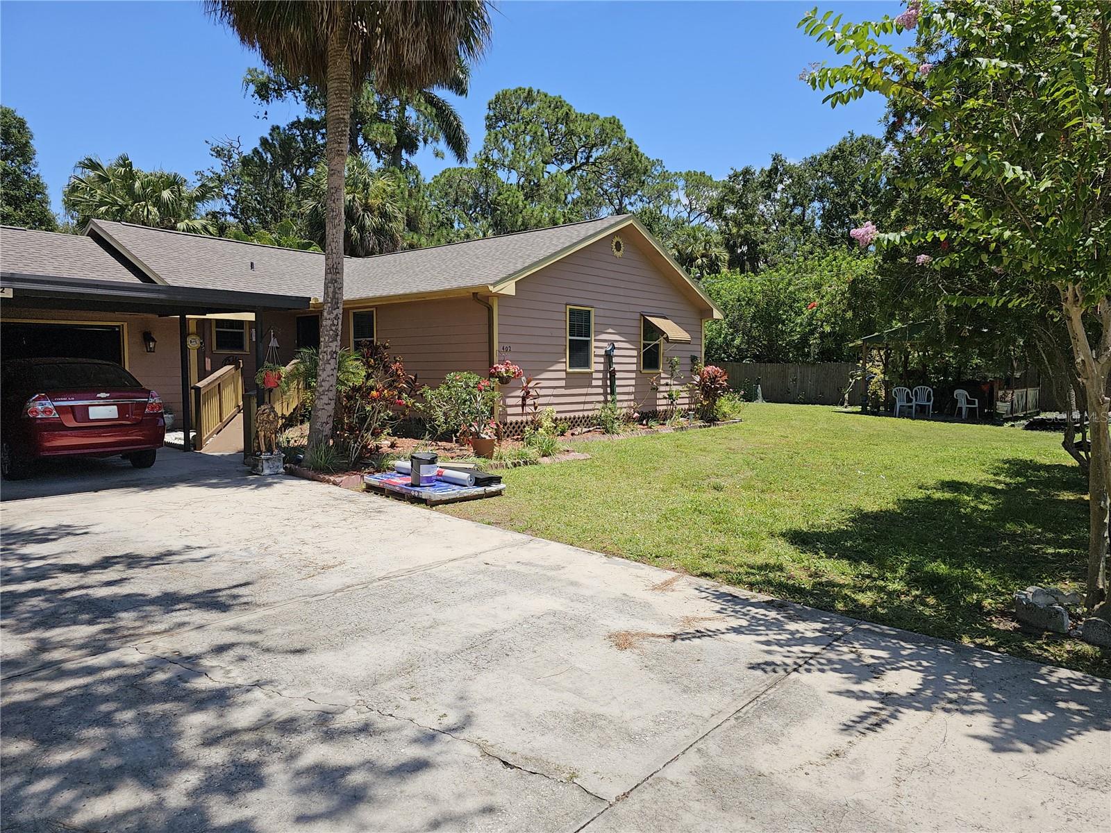 BRAND NEW SHINGLE ROOF!!Corner lot with room to roam and far from the Neighbors.SIT IN YOUR SWING AND WATCH THE WORLD GO BY! CURB APPEAL GALORE! This beautiful home has so much - a wonderful yard with plenty of space to sit in the shade or the back screen porch to relax and have your coffee or sip of wine. Up on entering you will park your car in the carport away from the Sun, or in the garage for more protection, entering the living room you’ll see the light come through all the different rooms for plenty of light, yeah cozy and comfy like a country home. Floors are easy care and kitchen is ample with eating space at the bar for breakfast and for your dining room set. This one got no water inside. It sits tall and proud. Make your appointment and come see this gem. Mrs. Green Thumb lives here!