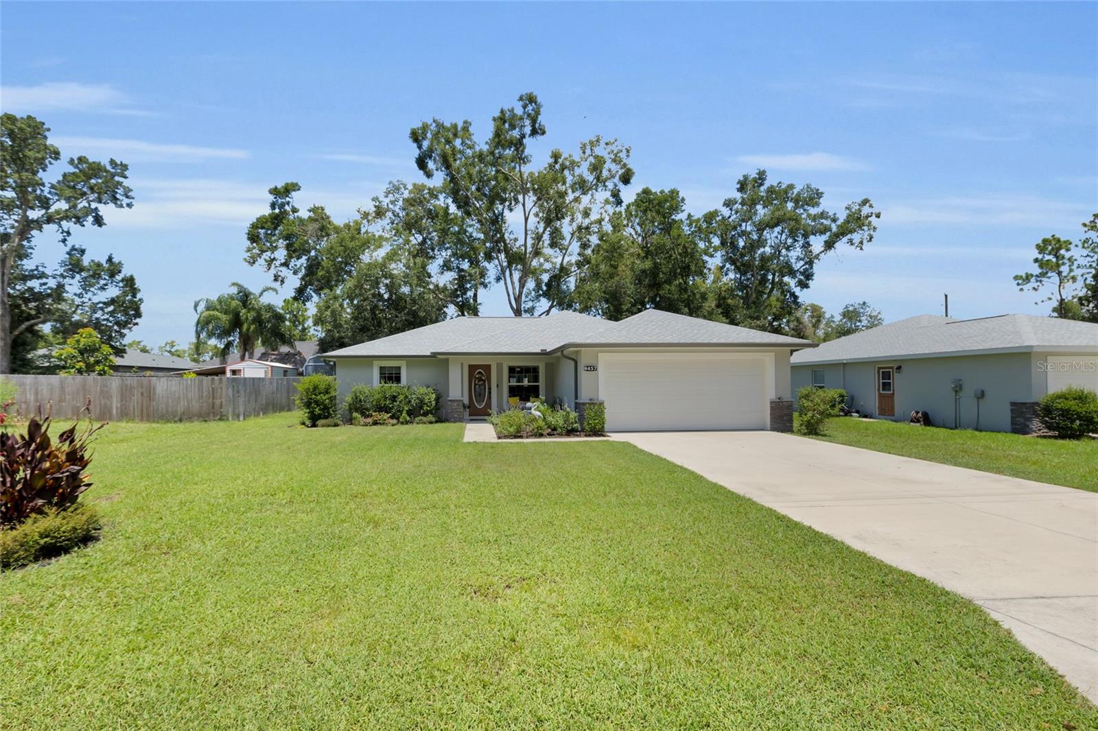 ** MORE PHOTOS TO COME** Welcome home to this beautiful MOVE IN READY home in Orange Blossom Hills. You will be pleased to find NO HOA, or CDD fees in this great family friendly community. This home consists of 3 Bedrooms, 2 Bathrooms, a 2 car garage and built of concrete block with well and septic for added savings with no water or sewer bill. As you enter the home you will notice the open floor plan, vaulted ceilings, and tile flooring. The kitchen features high end stainless steel appliances, shaker style cabinets with soft-close hardware, and granite countertops. In the master bedroom you will find the tray ceiling and walk-in closet. The master bath has dual sinks, shaker cabinets, granite countertops, and a seamless glass shower. On the other side of the home you will find both spare bedrooms with brand new carpet and large closets. The spare bathroom has shaker cabinets and granite counter tops with a tub/shower combo. Added features include window treatments, gutters, beautiful extended paver patio and all furniture, patio furniture, lawn equipment negotiable. Conveniently located near The Villages, Lady Lake and Ocala for all your shopping and dining needs.
