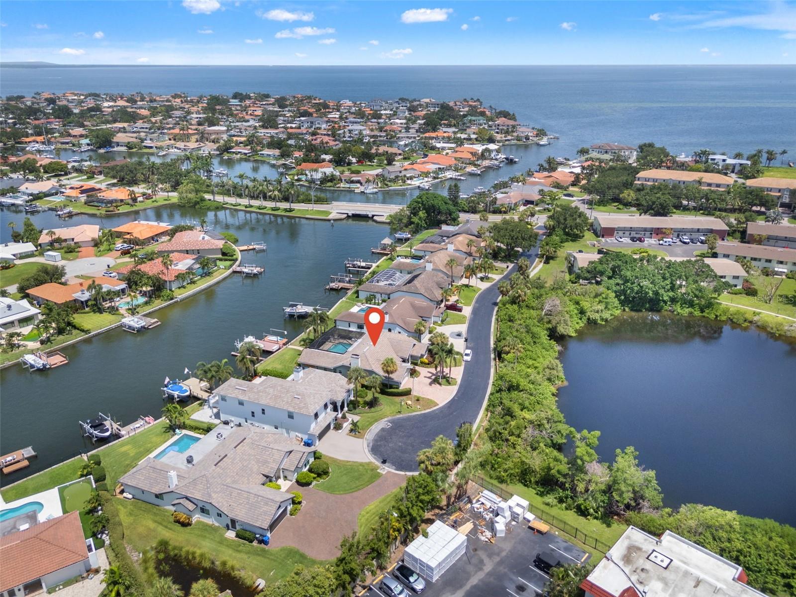 Rare opportunity! Waterfront pool home on a PRIVATE STREET with cul-de-sac in the highly sought-after Northeast St Pete area! Built in 1989 on higher elevation, every home on Alisa Circle passed last year's record-breaking tests with ZERO SURGE ISSUES. Just minutes from downtown, this stunning 4-bedroom, 3-bath, block home is located in the exclusive 8-home enclave of Venetian Place. A quiet cul-de-sac community, where privacy meets coastal elegance. Enjoy HIGH CEILINGS, tile roof (2014), UPDATED SEAWALL, plenty of parking on your circular driveway, plus, IMPACT WINDOWS and SLIDERS. Home is already setup for the most discerning outdoor enthusiast, including large dock with catwalk and fish cleaning station, boat lift, secondary lift for personal watercraft, and wide-open Tampa Bay just around the corner.
Very well-maintained property with a CLEAN 4 POINT INSPECTION in July of 2025! This stunning home offers not only peace of mind, but also the lifestyle everyone dreams of in Florida. Step outside to your sparkling saltwater pool, fully enclosed pool cage, and surrounded by tropical landscaping. The expansive covered patio is an entertainer’s dream, complete with a built-in grill, Green Egg smoker, and plenty of room to lounge or dine alfresco. French doors and large windows frame stunning water views from nearly every room in the house. The large, fenced backyard offers a safe, shaded space for pets or play, and leads directly to your private dock. Incredibly easy to launch your kayak, paddleboard, and other personal watercraft with your secondary lift! The dock and seawall offer fishing for snook, snapper, sea trout and sheepshead, all right from your own backyard.
A smart layout provides an open, airy feel throughout the home. Formal living and dining areas offer flexibility for entertaining or working from home. The heart of the home—the kitchen—is equipped with wood cabinetry, granite countertops, a gas range, and a casual dining space overlooking the water. A breakfast bar opens into the cozy family room featuring a fireplace for that special ambiance. The spacious primary suite offers a peaceful retreat with a walk-in closet, updated en-suite bath with a soaking tub, double vanities, and a separate shower. Three additional bedrooms and two full baths provide plenty of space and privacy for guests or family.
Drive your golf cart to thriving Downtown St Pete, starting your route on beautiful Bayshore Blvd, just two blocks away. Homes around Bayshore have been purchased for up to $7M in the last 2 years, making Venetian Place one of the area’s best-kept secrets at this price point, especially considering the larger lot. Once you're in Downtown St Pete, enjoy award-winning restaurants, parks, boutique shopping, and the waterfront marina scene. You're also just a short walk from LCC Day School and less than 25 minutes to the beaches and Tampa International Airport! Contact us to book your showing today!