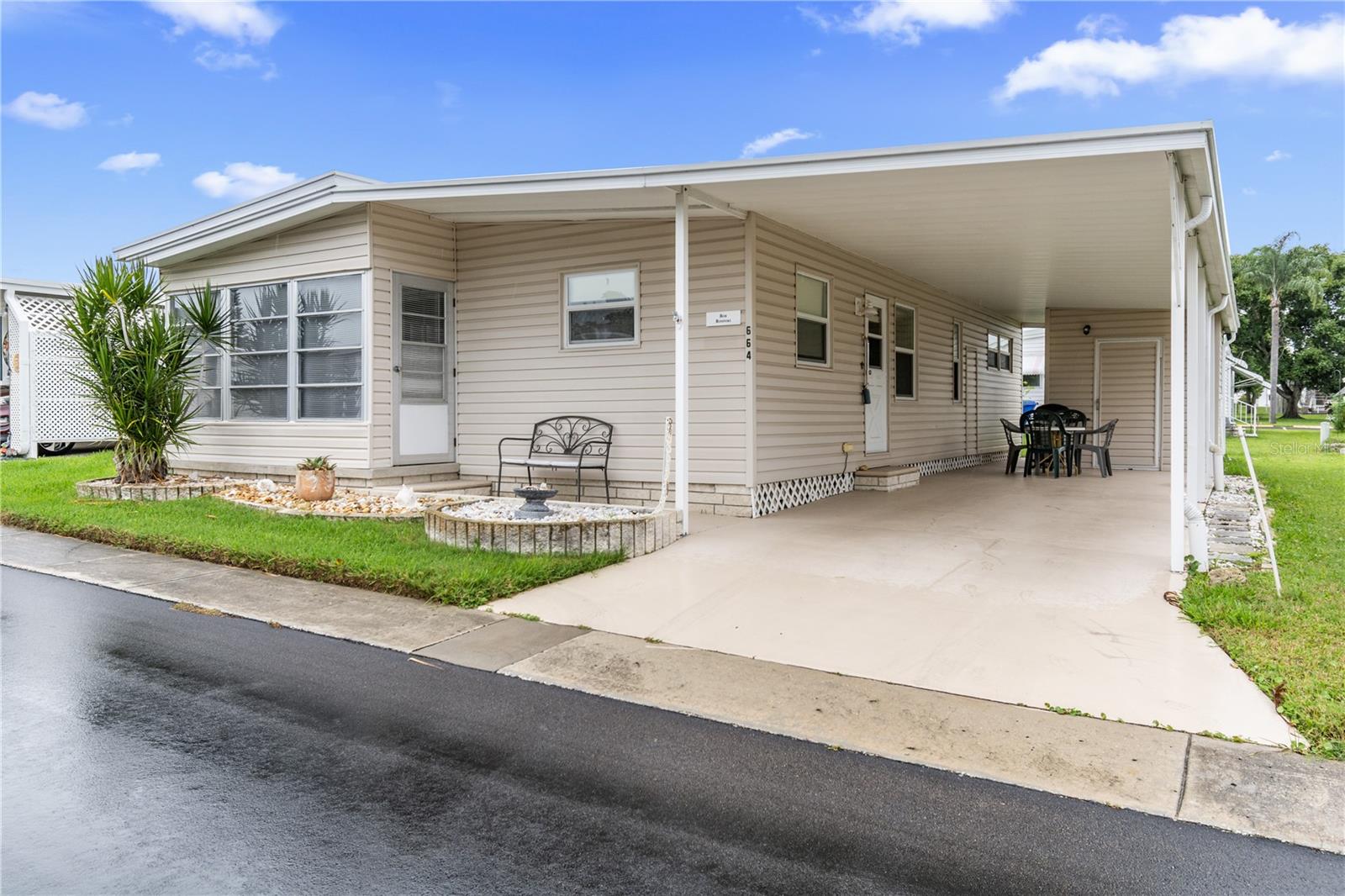 Welcome to your ideal Florida retirement retreat in the highly desirable Palm Hill Mobile Park, an active 55+ community in Largo, FL. This beautifully maintained and fully furnished, turnkey double wide manufactured home, offering both comfort and convenience. Featuring 2 bedrooms and 2 bathrooms, the spacious layout provides ample room for guests, while the large enclosed Florida room invites you to relax and enjoy the sunshine all year long. Recent upgrades include all new laminate flooring throughout and a replaced electrical breaker box in 2023, ensuring peace of mind and modern efficiency. Additional highlights include an indoor laundry room, plenty of storage space, and a covered carport for protected parking and extra outdoor living.
Palm Hill is one of Pinellas County’s most sought-after 55+ communities, offering exceptional amenities designed for active adults. Enjoy three swimming pools, two clubhouses, shuffleboard courts, a pool room, tennis and pickleball courts, and a golf course with optional membership. This golf cart-friendly neighborhood also features a spa, bicycle club, and a welcoming calendar of social events.
The monthly HOA fee includes lawn care, water, sewer, trash, cable, internet, and all amenities, providing simple, stress-free living. Perfectly located just minutes from top-rated Gulf beaches, excellent dining, shopping, and the vibrant cultural hubs of St. Petersburg, Clearwater, and Dunedin, this home is ideal for those seeking an active yet relaxed coastal lifestyle.
Please note: This is a cash-only purchase, as traditional financing is not available for co-op ownership. The share price is included in the asking price. Don’t miss your opportunity to own this updated, move-in-ready home in one of Pinellas County’s most vibrant 55+ communities. Schedule your private tour today!