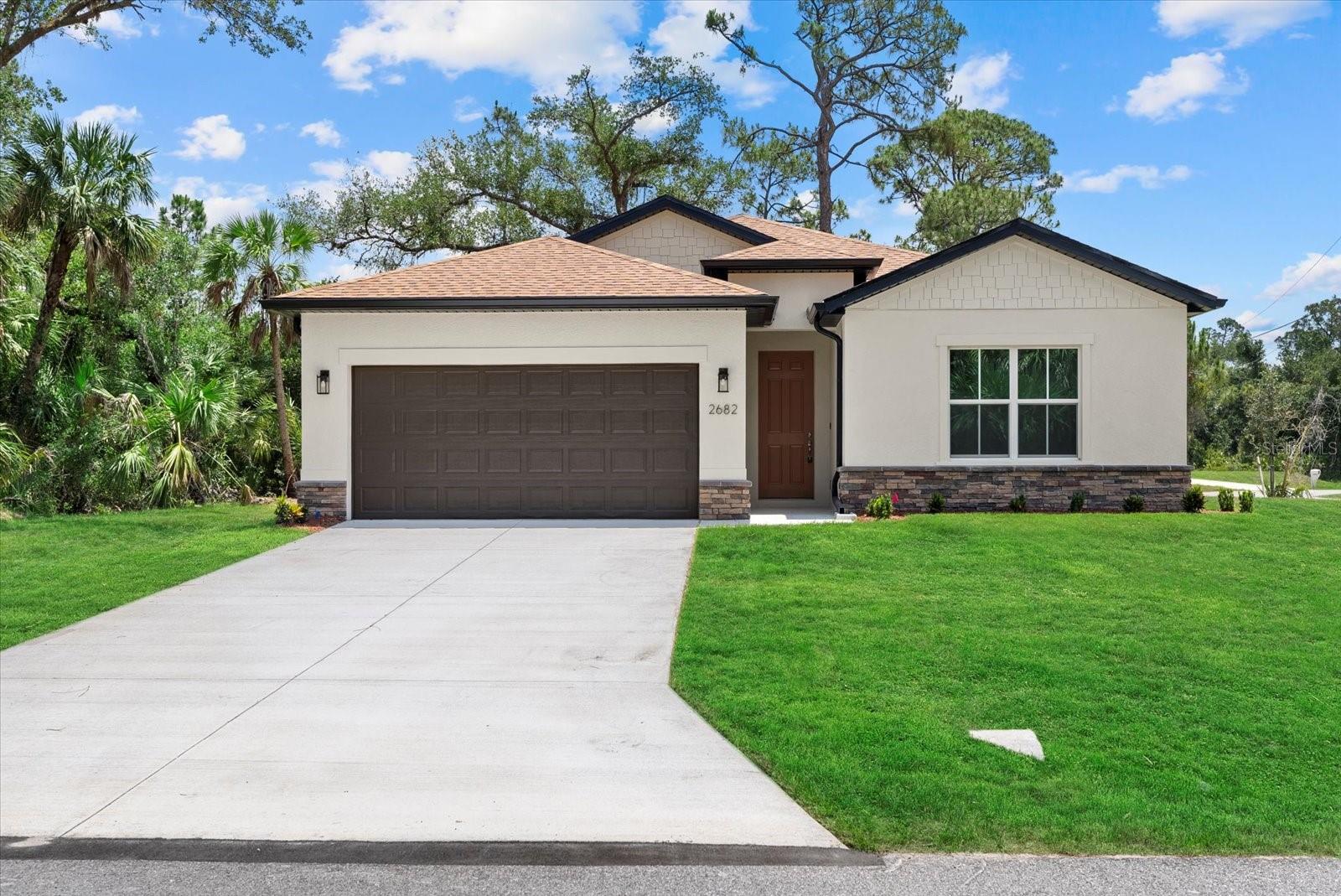 New Construction! Move-in Ready! Up to $10K in Seller Concessions for closing costs or Interest Rate Buy-Down. This beautiful 4-bedroom, 3-bathroom home on a corner lot with a 2-car garage is ready for you to call home. Step inside and be greeted by the spacious great room with soaring 9'4'' ceilings and elegant 8' doors throughout. The modern kitchen INCLUDES a stainless-steel Samsung appliance package, beautiful quartz countertops, and an open layout perfect for entertaining. The Primary bedroom comes complete with a tray ceiling, dual walk-in closets, and a spa-like ensuite with double vanities. The fourth bedroom, located at the front of the house, offers privacy with its own ensuite bathroom, perfect for guests or extended family. This home is packed with high-end finishes, including hurricane-impact windows, tiled showers, stylish and durable flooring, irrigtion system, and a Ring doorbell. Enjoy Florida living year-round on the covered lanai, ideal for outdoor relaxation. Selling concessions are available to make your move even easier! No HOA fees, no CDD. Schedule your showing today!