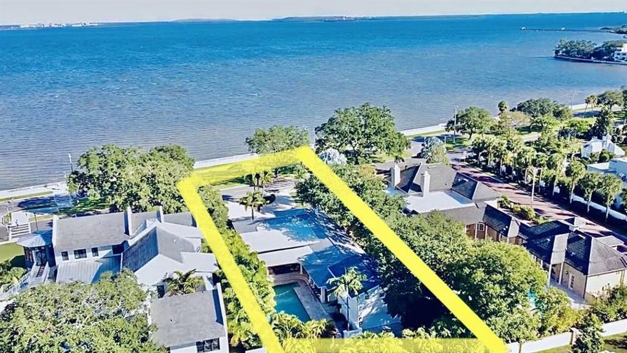 A rare find — this gorgeous turn key trophy home looks out on the blissful waters of Tampa Bay. The magnificent luxury one-story home is nestled on the highly sought-after, Bayshore “Billionaire” Boulevard. Elegantly remodeled to highlight a gorgeous midcentury-modern interior, cascading light from the enormous picture windows and 70 feet of breathtaking waterfront views framed by downtown Tampa's skyline. Inside, the wide-open spaces are ideal for Southwest Florida living. four bedrooms, four-and-a-half baths, plus an above-garage guest suite complete this magnificent property. Perfect for entertaining, the pristine gourmet kitchen has been beautifully updated with granite waterfall countertops, porcelain tile and a Viking gas stove. Accompanying the kitchen, you'll find a freshly designed wet bar updated with new granite countertops and floating shelves adjacent to the voluminous family room, plus a temperature-controlled 450-bottle wine room to house your favorite collections. Restore and rejuvenate in the generous first-floor master suite, boasting refinished bamboo flooring and French doors. The huge master bath features dual vessel sinks, new stone and tile accents and an exquisite rainfall shower. Outside, through French doors, a true tropical oasis begins to come together with lushly landscaped swaying palms, an oversized pool, an outdoor kitchen with a built-in grill, a wet bar with countertop seating and a convenient pool half-bath. This home is complete with a rear-entry two-car garage, paved circular driveway and ample parking spaces in the front and back.