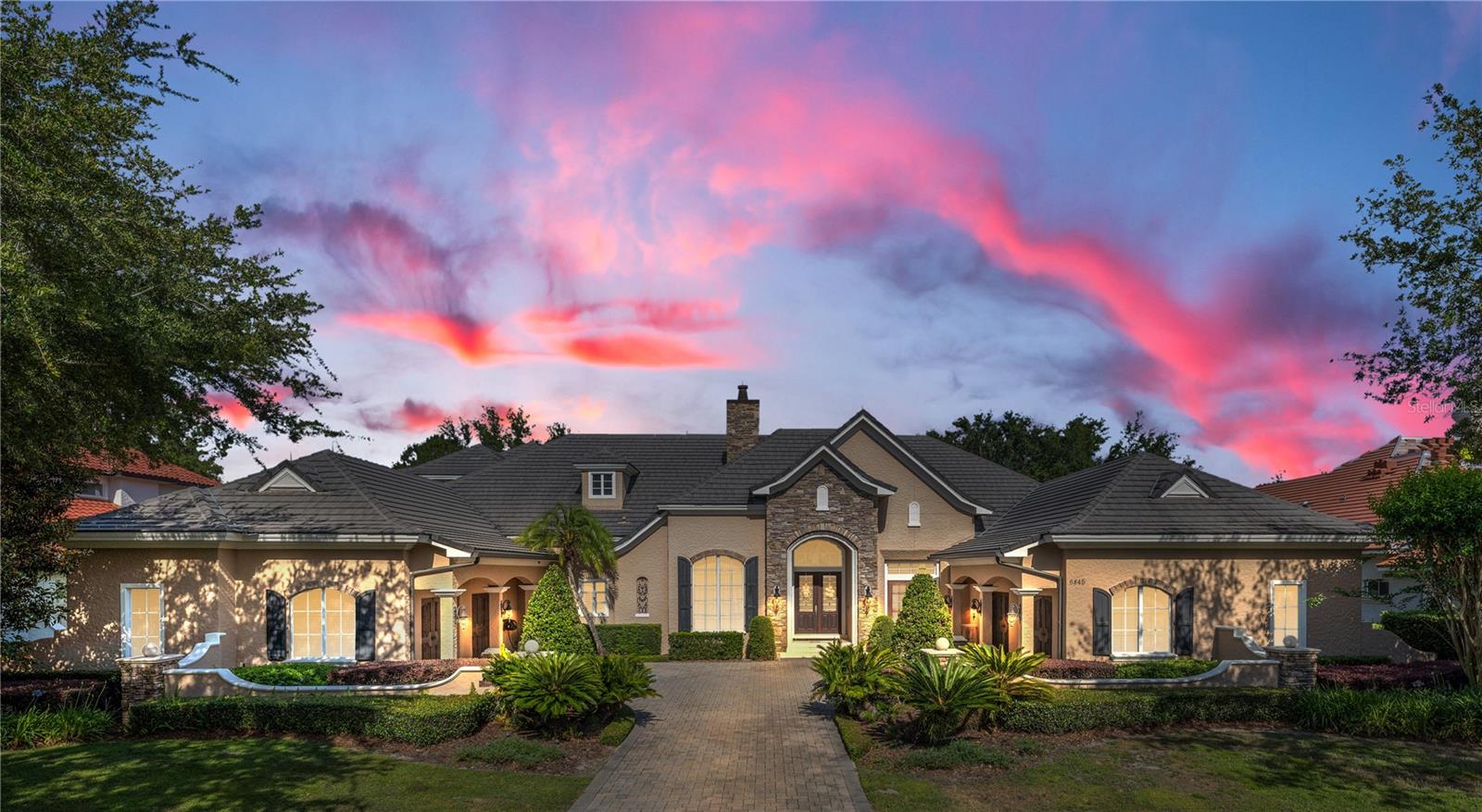 Experience timeless elegance combined with the tranquil ambiance of the golf course in this magnificent 5BR/5Full baths/2-half bath French Country Custom Home in Keene's Pointe, a guard-gated golf course and lakefront community in Windermere, Florida. Positioned along the picturesque 17th fairway of the esteemed Jack Nicklaus Signature Golf Course, this residence epitomizes the grandeur of its sprawling 7,500 square feet of air-conditioned living space. Boasting a coveted 4-car garage with epoxy floors, a spacious screen-enclosed pool, spa, fireplace, and an impressive summer kitchen complete with hospitality bar and dining area, all designed with entertaining in mind.
The thoughtfully designed floor plan showcases 4 ENSUITE BEDROOMS on the main level, alongside a refined wood-paneled study, a seamlessly integrated Kitchen-Family Room combo leading to the pool through 90-degree sliding doors and an adjacent oversized game room with a walk-around bar. On the second floor, you will discover another generously sized ensuite bedroom, accompanied by an expansive game room opening onto a private screened balcony, offering captivating golf course views. A wet bar and powder bath nearby ensure endless entertainment possibilities for friends and family alike.
The kitchen features top-of-the-line appliances, including side-by-side double Subzero refrigerators with four freezer drawers, a Wolf gas range with oven, a built-in wall oven, microwave, and warming drawer. Dual dishwashers effortlessly cater to large gatherings, while light wood on-trend custom cabinetry provides ample storage, complemented by a hidden oversized pantry. The laundry room, larger than most bedrooms, enhances convenience and functionality. Classic travertine flooring in a light neutral tone unifies the main floor, adding to the home's timeless allure.
Crafted with precision by Master Custom Builder Rick Watson, this residence transcends the ordinary, offering a level of luxury and spaciousness rarely found in golf course estate homes. Impeccably and elegantly appointed, this home is a must-see masterpiece.