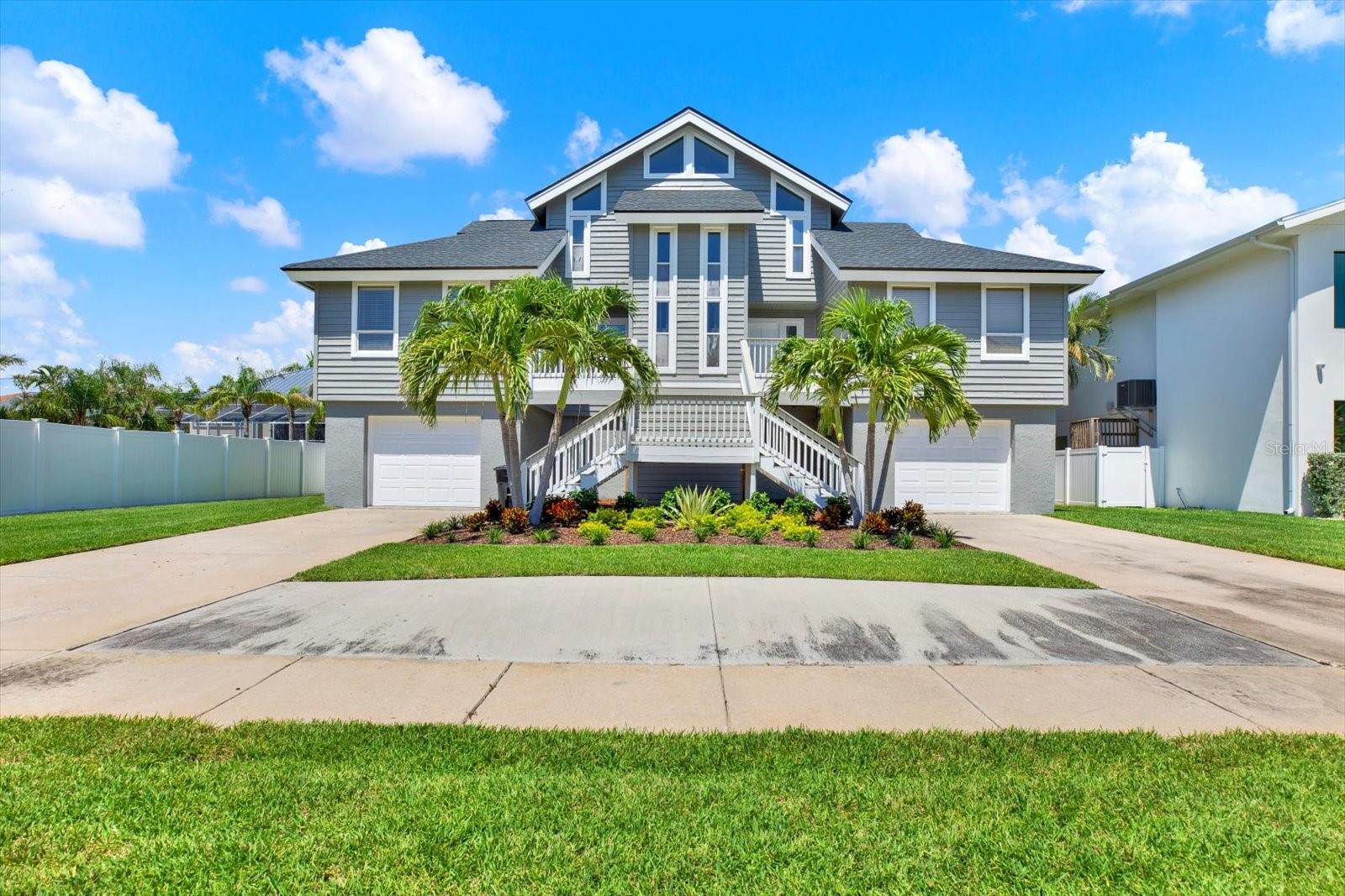 WELCOME TO THIS FABULOUS 3-STORY POOL HOME LOCATED IN THE PRESTIGIOUS, GATED COMMUNITY OF PASADENA YACHT AND COUNTRY CLUB IN GULFPORT! Boasting exceptional curb appeal with fresh landscaping and exterior paint, this beautifully maintained 4-bedroom, 3-bath residence offers over 2,600 SF of comfortable living space. The ground level features 2 TANDEM GARAGES WITH SPACE FOR UP TO 4 VEHICLES, plus a spacious bonus room—ideal for a home gym, playroom, or additional storage. Step inside the main level to discover a light-filled floor plan with SOARING CATHEDRAL CEILINGS and warm wood flooring throughout the main living areas. Enjoy both formal living and dining rooms, as well as a cozy family room complete with a wood-burning fireplace. The chef’s kitchen is a standout, featuring abundant wood cabinetry, granite countertops, stainless steel appliances, a built-in desk, breakfast bar, and an adjacent dinette with sliding doors leading to the rear patio. THE MAIN LEVEL ALSO INCLUDES A GENEROUS PRIMARY SUITE WITH ACCESS TO THE PATIO, WALK-IN CLOSET, VAULTED CEILINGS, AND A LUXURIOUS EN SUITE BATH WITH SOAKING TUB, WALK-IN SHOWER, AND DUAL VANITY. A 2nd bedroom, guest bath, and laundry room complete this level. Upstairs, you'll find 2 additional bedrooms and a 3rd full bath, offering flexible space for family or guests. Outside, your private backyard oasis awaits with a sparkling SALTWATER POOL, new sod, and city water-fed irrigation system. Additional highlights include a BRAND NEW ROOF (2025), providing peace of mind for years to come. As a new homeowner, enjoy immediate access to exclusive social or golf memberships (for additional fees) with no waitlist required! Don't miss this rare opportunity to own in one of Gulfport’s most desirable communities. Schedule your private showing today!