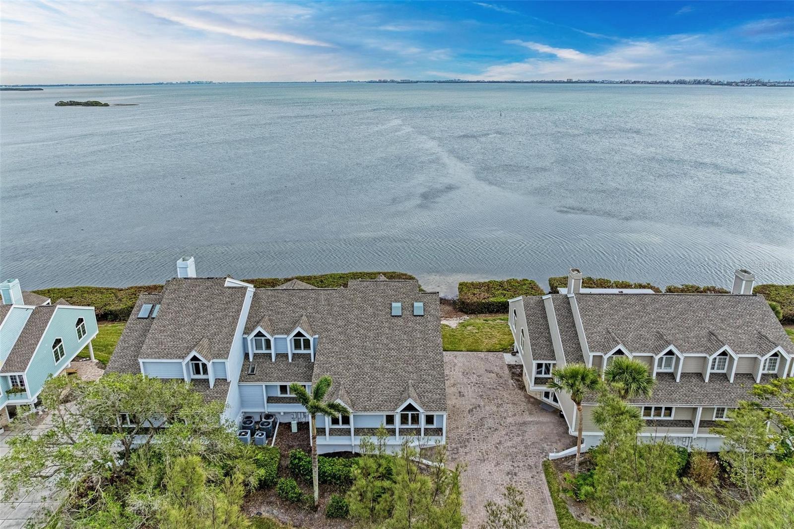 Welcome to your dream waterfront retreat on beautiful Tidy Island! Nestled on one of the best view lots in this cozy, low-density community, this spacious townhome offers stunning panoramic views of Sarasota Bay from Downtown Sarasota all the way to Longboat Key. With 2 bedrooms, a den, and a private elevator, this home is perfect for those who love waterfront living. Recently updated with over $115,000 in modern enhancements, this home is ready for you to move in and enjoy! Step inside to find beautifully remodeled bathrooms featuring elegant marble tile and stylish vanities, along with bamboo flooring that adds warmth to all living areas. The kitchen is a chef's delight, showcasing brand new high-end stainless steel LG appliances, a new washer and dryer, and a cozy breakfast bar, perfect for sipping your morning coffee while soaking in those gorgeous bay views. The layout is designed for comfort and enjoyment, with breathtaking views from every room. You'll find the main living area and guest bedroom on the second level, while the owner’s suite and a private office are on the third level. The spacious primary suite features new bamboo flooring and an updated en-suite bath with a rain shower head and a custom glass enclosure, providing a luxurious retreat to unwind. Your new home also includes an oversized 2-car garage with a new hurricane-rated, insulated garage door and a handy extra storage room. Tidy Island is a true gem; it’s one of the few low-density communities with only 94 residences nestled among 240 acres of protected wildlife and bird sanctuary. This gated community boasts charming coastal New England-style architecture and offers fantastic amenities, including a lakefront clubhouse, swimming pools with hot tubs, tennis courts, a fitness room, walking and jogging trails, and even a kayak storage area to enjoy all that the water has to offer. You’ll love the locationÂclose to beautiful Suncoast beaches, fantastic shopping, vibrant dining options, healthcare facilities, multiple golf courses, and the IMG Sports Academy. It’s the perfect peaceful retreat, yet still conveniently close to everything you need. Furnishings are available for an additional charge and are optional, making this home truly customizable to your style. Don’t miss out on this incredible opportunityÂcall today for your private showing! We can’t wait to welcome you home!