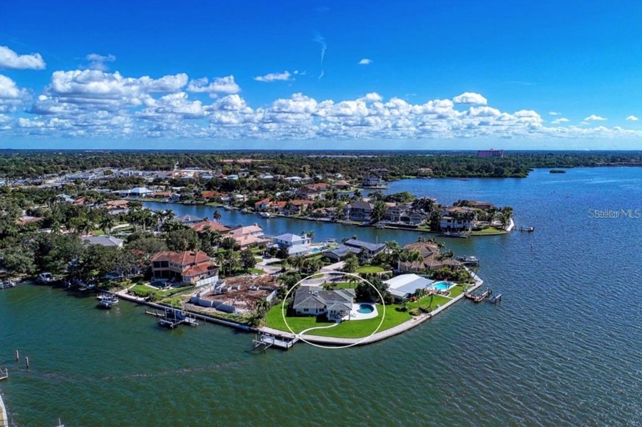 Unfurnished. Annual lease. This is a rare opportunity to rent one of Sarasota's premier waterfront properties at the end of a quiet cul-de-sac jetting out into Dolphin Cove. This spectacular property on Sarasota Bay features 210' feet of deep water for large boat/sailboat with unobstructed breathtaking views with three walls of windows. Open design Florida home with original front door, split floor-plan with two master suites, one with direct pool access. The Gourmet Kitchen has quartzite counter tops, custom cabinets have solid wood drawers, dual dishwashers, larger sink, under counter filtration system, double ovens with a microwave/convection on top and a convectional roasting oven on lower, matching refrigerator with ice maker, and a built-in wine refrigerator. Second wine refrigerator. Living-Dining Room have motorized sun-out blinds with remote control. Master Suite with attached full bath includes dual sinks, Jacuzzi tub with jets and walk-in shower, walk in closet and electric fireplace, opens to backyard. Laundry room w high efficiency washer/dryer. Covered rear patio with compressed shell-stone floors. NOTE: Boat dock and lift was damaged in the hurricanes and will be rebuilt. Dock is located to right side of water front sea wall by design so as to not block the water view. Pebble tech swimming pool in shell-stone paver deck w oblong shells that glisten in the light. First, Last, Security deposit, and application required for move-in. Background and credit check performed. Landscaping and pool maintenance services included.