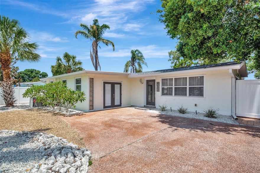 Step inside this lovingly updated Sarasota gem and experience the harmonious blend of classic Florida living and crisp, contemporary design. Nestled on a lush, professionally landscaped corner lot in a highly sought-after, no-HOA neighborhood, this 3 bedroom, 2.5 bathroom home delivers the open, sun-splashed lifestyle everyone is searching for. As you walk in, you will discover a true entertainer’s dream. The open-concept layout revolves around a beautifully designed chef’s kitchen outfitted with quartz countertops, a deep farmhouse sink, upgraded stainless steel appliances, and a striking stone-and-metal backsplash that sets the tone for unforgettable gatherings. The living and dining areas are flooded with natural light thanks to the home’s southern exposure and a series of sliding glass doors that line the walls, creating an effortless transition to the screened lanai and bringing the outdoors in. Bamboo flooring adds warmth and style throughout, complementing the fresh, coastal feel. The spacious primary suite is a private sanctuary featuring custom, hand-crafted solid-wood closet doors and a wide sliding glass door that opens directly to the lanai—a picturesque spot for enjoying a quiet morning coffee or a warm evening breeze. The second bedroom continues the theme of artisan touches with more custom closet doors, while the third bedroom, with its own separate exterior entrance and en-suite half bath, offers flexibility as a guest suite, home office, fitness studio, or creative space. The screened lanai is a true extension of the living area, featuring a beautifully crafted wood-accented ceiling that adds charm and character. This fully fenced outdoor space is ideal for relaxing, dining, or entertaining year-round. Encircling the home, vibrant tropical landscaping boosts curb appeal and creates a serene, secluded atmosphere—perfect for hosting casual neighborhood barbecues, unwinding with a good book in a hammock, or letting pets play freely. Located just a half mile from Arlington Park, this home serves as the prime gateway to a vibrant, active lifestyle with a wide array of local amenities right at your fingertips. From swimming laps at the aquatic center and working out at the gym to enjoying outdoor fitness stations, shooting hoops, playing tennis, or meandering along scenic walking trails, there’s no shortage of ways to stay engaged and connected. Even your four-legged friends will love the two nearby dog parks. Beyond the neighborhood, you’re only minutes from Sarasota’s world-famous beaches, its lively downtown arts and dining scene, and highly rated schools—all within one of the city’s most desirable and minimally restricted neighborhoods, and no HOA fees. Move-in ready and full of upgrades, NEW AC AND FENCE IN 2022. HOME WAS FULLY RE-PIPED IN 2023, GUTTER GUARDS AND FULL IRRIGATION SYSTEM. Don’t miss your chance, schedule your showing today and experience the lifestyle you've been dreaming of!