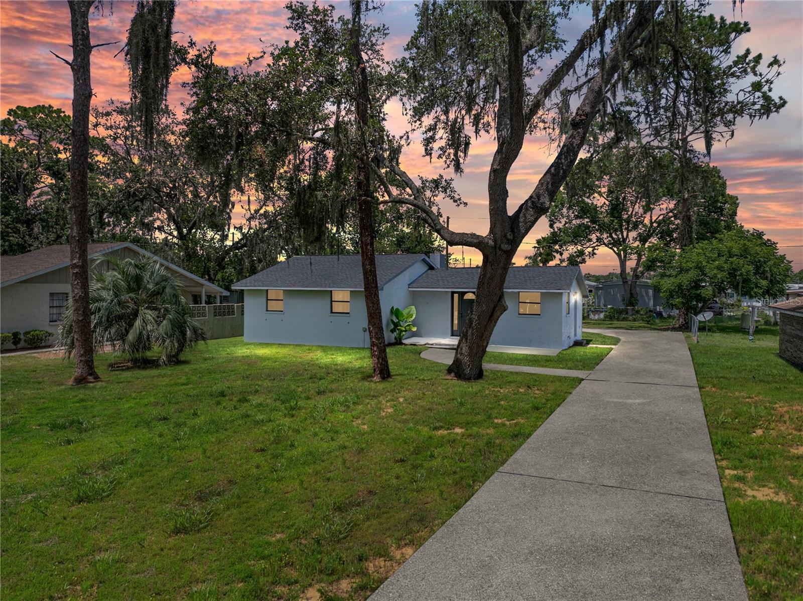 So many upgrades! This one checks all the boxes! Set beneath shady trees on over a 1/4 acre, this
3 bedroom, 1.5 bath home with a detached 1 car garage offers an inviting setting and plenty of
personality in a central Zephyrhills location. Over the past few years, it has seen a thoughtful
refresh, including: a 2022 roof, a 2024 septic tank and drain field, 2022 electrical panel, 2022
remodeled kitchen, 2016 AC, 2022 water heater, newer garage door, some newer windows, fresh paint inside and out and the trees on the property were trimmed August 2025. The eat-in kitchen has been completely reimagined with granite counters, soft close cabinetry,
stainless steel appliances, vinyl flooring, a decorative backsplash, pantry, and a cozy eat-in dinette with a charming storage nook. An inviting living room awaits just off the kitchen with wood beam accents, plush carpet flooring, and a stone-faced wood burning fireplace creating a
warm focal point for gatherings. The primary bedroom includes a cedar-lined walk-in closet and a private half bath that flows directly into the updated full bath, featuring granite counters, upgraded lighting and mirror, a walk-in shower, and a convenient laundry closet. Two additional bedrooms provide flexible space for guests, work, or hobbies. Outside, the partially fenced yard offers plenty of room to enjoy the outdoors, while the detached garage provides opportunity for secure parking, a workshop, or storage. Recent tree trimming adds to the home’s curb appeal, making it move in ready for its newest owners! Call us today for your private tour!