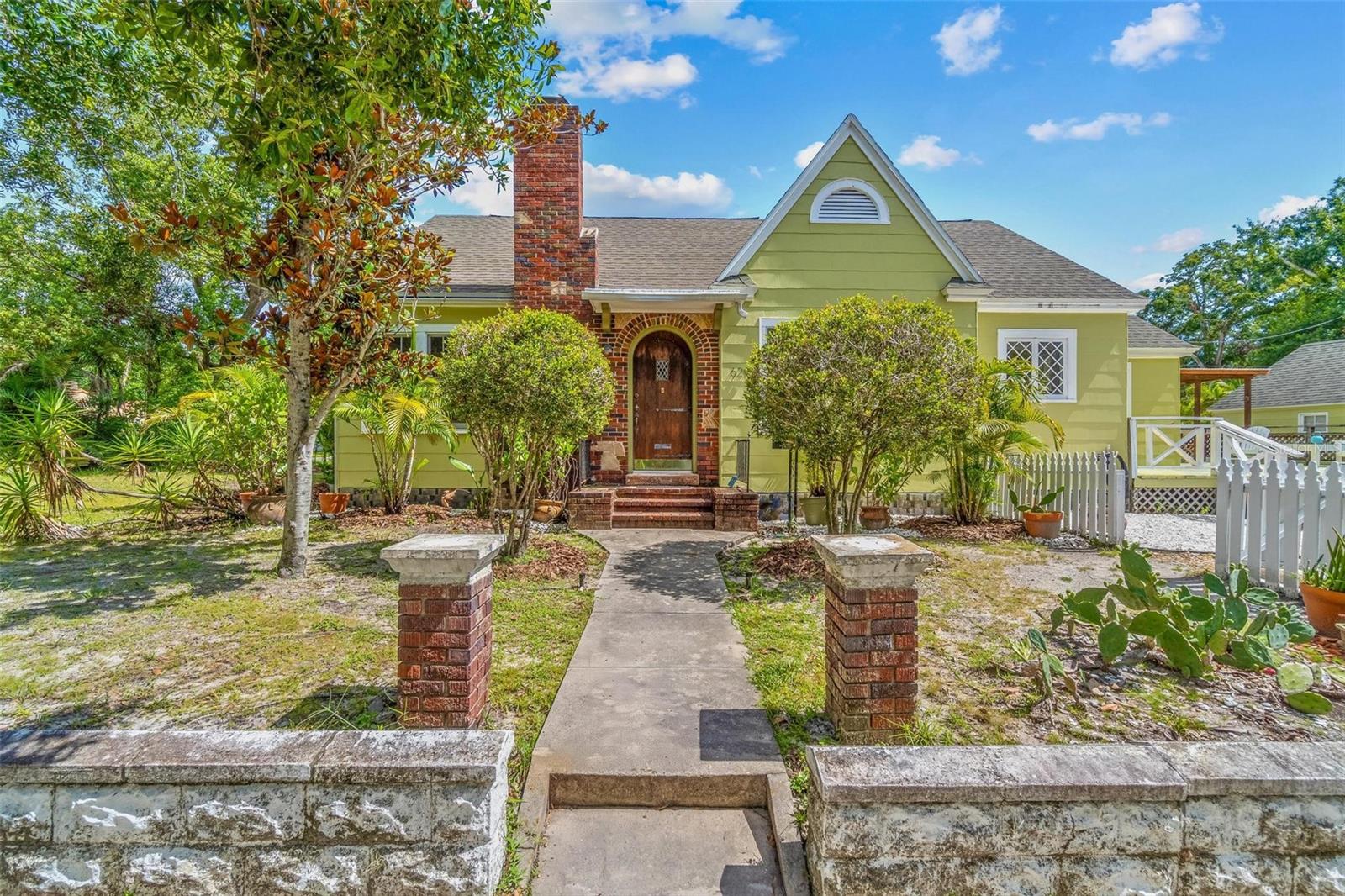 Step into timeless elegance with this breathtaking Tudor-style home located in the heart of Crescent Heights. From its charming curb appeal to its thoughtfully preserved interior details, this home is filled with character and warmth. An arched front door welcomes you inside, where you'll find a cozy fireplace, soaring 9-foot ceilings, an abundance of natural light from generously-sized windows, rich hardwood floors, and impressive spaces throughout. Whether you are looking for a retreat, a space to unwind after work, or if you want to be encompassed by peace yet be within a few short minutes from the best of St Pete, this is your sanctuary! Situated on a corner lot, the property also boasts a large outdoor deck—ideal for hosting gatherings or enjoying quiet evenings under the stars. The versatile sunroom/bonus room provides additional space for an office, playroom, or relaxing retreat. Just two blocks away is the beautiful 56-acre Crescent Lake Park, offering a lake, playground, jogging trails, a ball field, and a dog park. Enjoy the best of both worlds: a serene neighborhood setting with unbeatable proximity to vibrant Downtown St. Petersburg, where you’ll find waterfront parks, world-class museums, shopping, dining, and entertainment—all just minutes from your door!