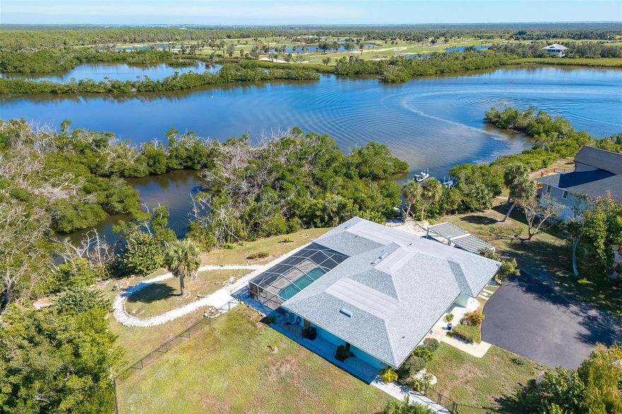 MUST-SEE WATERFRONT HOME! This private retreat is located in the desirable Placida Pointe area, just a short distance from Boca Grande and the miles-long walking and biking path along Placida Road. Best of all, per recorded documents, the parcel is grandfathered out of the HOA, allowing for no HOA fees or covenants (buyer to confirm).
Experience the ultimate Florida lifestyle in this beautifully updated Key West–style retreat situated on an oversized waterfront lot with direct access to the Gulf of Mexico. Located on tranquil Coral Creek with 160 feet of creek frontage and 125 feet of canal frontage, this exceptional property offers serene views, abundant privacy, and endless outdoor enjoyment. A private screened lanai with a heated saltwater pool and travertine deck provides an inviting space to relax, while the dock—complete with lighting and a fish-cleaning station—offers the perfect setting for fishing or launching your kayak and paddleboard, or your own center console boat, for a new adventure each day. The fenced yard is ideal for dogs, and the property includes ample space to park an RV and/or boat. 
Inside, the spacious layout includes a great room, family room, dining area, and large guest rooms with oversized closets. The open-concept gourmet kitchen serves as the heart of the home, featuring custom inset cabinetry, Luxor quartz countertops, porcelain beach wood-plank tile flooring, and top-of-the-line Jenn-Air appliances including a 6-burner gas range, refrigerator, island drawer microwave, Bosch dishwasher, and large basin sink. The primary suite offers a beautifully updated bath with a walk-in shower and double vanity, while the laundry room provides convenience with custom cabinetry and a utility sink. Throughout the home, thoughtful updates and premium finishes enhance comfort and coastal elegance.
Recent upgrades bring peace of mind and energy efficiency, including a new roof (2020) with strapping and third nail, new HVAC with raised units (June 2024), tankless hot water heater, two 125-gallon propane tanks, generator hook-up, relined pipes with a ten-year warranty, new Hardie board lanai ceiling, new front door, reinforced soffits with cross members, partial impact windows, new security system, and added canned lighting in the garage. Combining waterfront living, modern upgrades, and a premier location, this home truly captures the best of coastal Florida living.