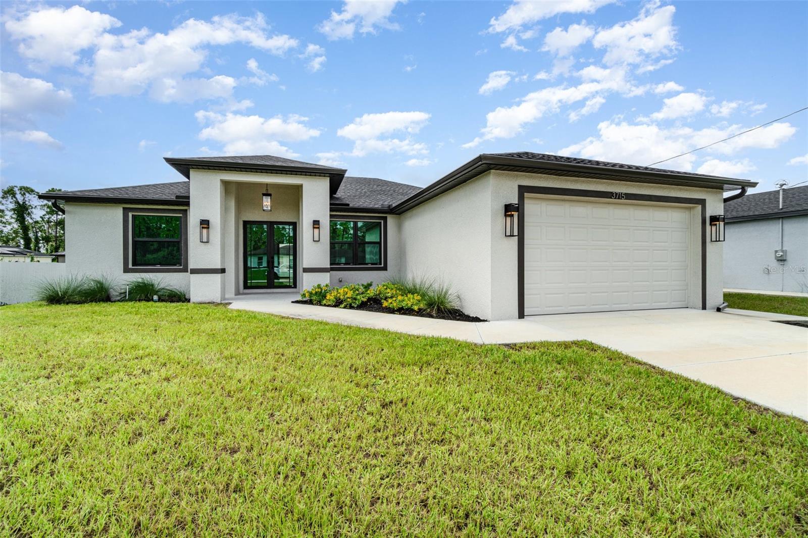 Welcome to your dream home, a brand-new construction in a prime central location in Lehigh Acres. This home offers a perfect mix of luxury, style, and convenience, built with exceptional quality and attention to detail. It's designed for modern living and peace of mind. This spacious 3-bedroom, 2-bathroom residence features a versatile den that's perfect for a home office or cozy reading nook. The split floor plan ensures privacy, with the luxurious primary suite tucked away on one side of the home. The primary suite is a true retreat, boasting an elegant tray ceiling and two spacious walk-in closets. In the spa-like primary bathroom, you can relax in a standalone soaking tub or enjoy the sleek, frameless shower. The bathroom also features two separate sinks and vanities, along with a private water closet. The heart of the home is the chef's kitchen, which features high-end GE brand stainless steel appliances, elegant quartz countertops, and soft-close cabinetry with a beautiful tiled backsplash. This space flows seamlessly into the large great room, making it ideal for entertaining. Throughout the home, you'll find 8-foot doors, decorative lighting and fans, and stunning large tile flooring. The living room also has a tray ceiling, adding an extra touch of sophistication. Beyond the stunning interior, you'll find top-of-the-line features for comfort and security. Hurricane impact windows and doors provide superior protection and energy efficiency. The exterior features a beautifully landscaped yard with lawn irrigation, which you can view from the screened-in lanai. The builder even added an integrated pest control system, allowing for easy access and a pest-free home. This fantastic location puts you close to everything you need. You're just a short drive from RSW International Airport, SR-82, and I-75, making travel a breeze. Enjoy the excitement of Spring Training for the Boston Red Sox and Minnesota Twins, or explore the area's excellent shopping and dining. When you're ready for a day in the sun, the beautiful Gulf Coast beaches are not far away. This home is more than just a place to live—it's a lifestyle. Come see what makes this brand-new home so special.