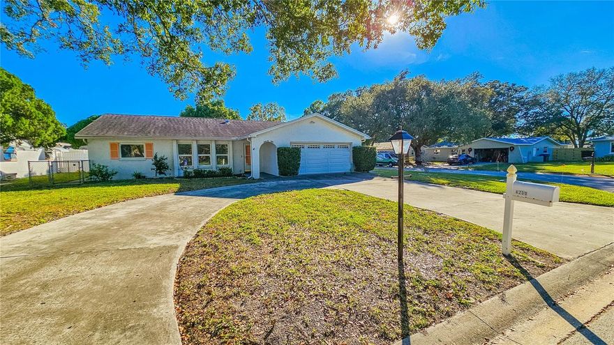 One or more photo(s) has been virtually staged. AMAZING Home! This 3-bedroom  2-bath home on a corner lot in highly desirable Kenneth City’s Tenaglia Estates has been well maintained by the same owners for over 35 years. It offers a large formal living room, spacious dining room and  family room, galley style kitchen, plus a split bedroom floorplan, with ample closet space. Move right in or update to match your Kenneth City lifestyle. The garage houses two cars, plus lots of storage with the washer & dryer included in the sale. Solid exterior features include storm-ready reinforced garage door, recent roof, and metal awnings that close down to become storm barriers. The cozy fenced backyard, combined with an enclosed porch, is perfect for weekend cookouts and entertaining. A large shed is ready to become your workshop, with more storage space than a PODS, or a mechanic’s man-cave. Tucked away on a quiet well-groomed street, this is conveniently located close to St Petersburg General Hospital, shopping on 66th St. or at Tyrone Mall, and 15 minutes from downtown St. Petersburg. This is an opportunity you do not want to miss.