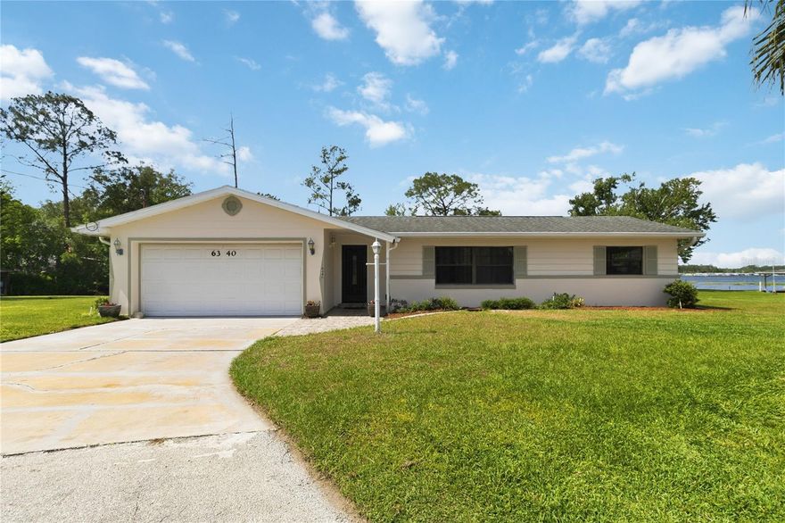 Tucked away at the end of a quiet cul-de-sac in New Eden on the Lakes, this waterfront retreat captures the kind of laid-back Florida lifestyle that’s getting harder to find. Set on over half an acre, the property stretches from a canal out to the open waters of Center Lake, offering direct access to the Chain of Lakes and front-row seats to vibrant sunset skies.
Inside, the home balances comfort and function with a split-bedroom layout, three bedrooms, two bathrooms, and two distinct living spaces—perfect for gathering or spreading out. Natural light and water views carry through to a spacious screened-in patio, where mornings feel peaceful and evenings become something special.

Beyond the main home, a 343 Sqft separate workshop opens the door to endless possibilities. Whether you envision a guest cottage, creative studio, or private office, the space is ready to evolve with your needs. Out back, a private dock and boathouse make getting on the water effortless, and a public boat ramp just a block away adds even more convenience.

With no HOA or CDD, you’ll enjoy flexibility without sacrificing location—close to shopping, dining, medical facilities, and within an easy drive to Florida’s beaches. The washer and dryer are included and located in the garage, along with a riding mower to help maintain the expansive grounds.

If you’ve been searching for space, water access, and a setting that feels like a hidden escape while still being close to everything, this property delivers a rare opportunity to make it your own.

One year home warranty included with a full price offer.
