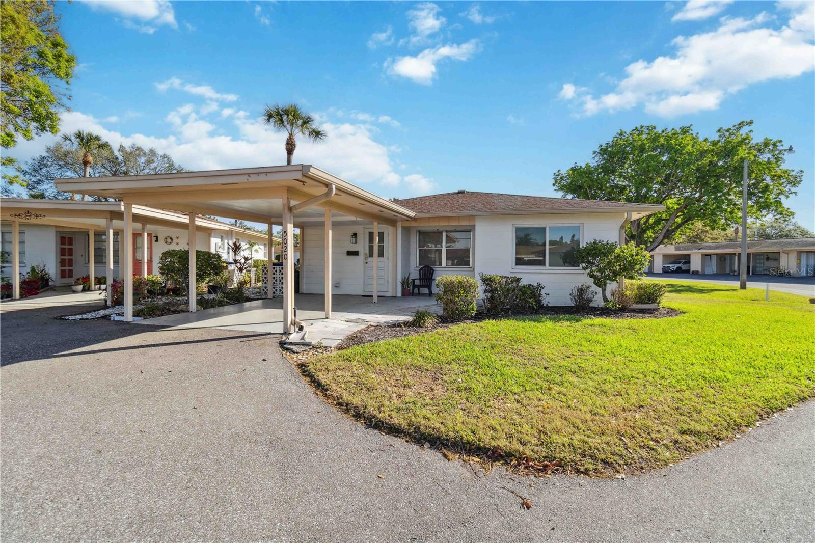Discover the perfect blend of comfort and convenience in this adorable stand-alone villa nestled in the peaceful community of Oakwood Villas. This well-maintained home offers privacy, low-maintenance living, and an inviting floor plan. The primary suite includes an ensuite bath and generous closet space, while the second bedroom is ideal for guests, a home office, or a hobby space. The covered carport helps to protect your vehicle from the elements and provides convenient parking. You'll enjoy the updated vanities and fixtures in both bathrooms, and with laminate flooring and tile throughout, cleaning is a breeze. The community pool is nearby and owners have use of the clubhouse as well. This quaint property is the perfect starter home, or second home retreat.