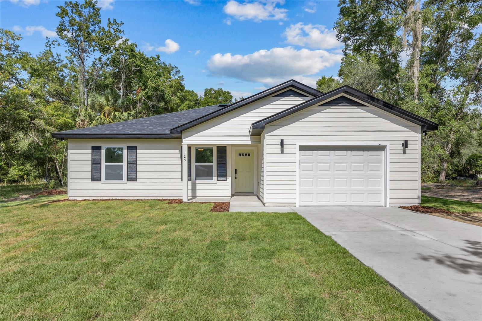 Stunning New Semi-Custom Home in Four Lakes, Hawthorne, FL! This beautifully crafted 3-bedroom, 2-bathroom home sits on over an acre and features an open floor plan with luxury vinyl plank flooring throughout. Enjoy a modern kitchen with stainless steel appliances and elegant porcelain countertops, also found in both bathrooms. The primary ensuite boasts a porcelain-tiled shower, while upgraded light fixtures and ceiling fans add style throughout. Surrounded by mature trees for natural privacy, the spacious backyard is ready for your personal oasis. Don't miss this opportunity—schedule your tour today!