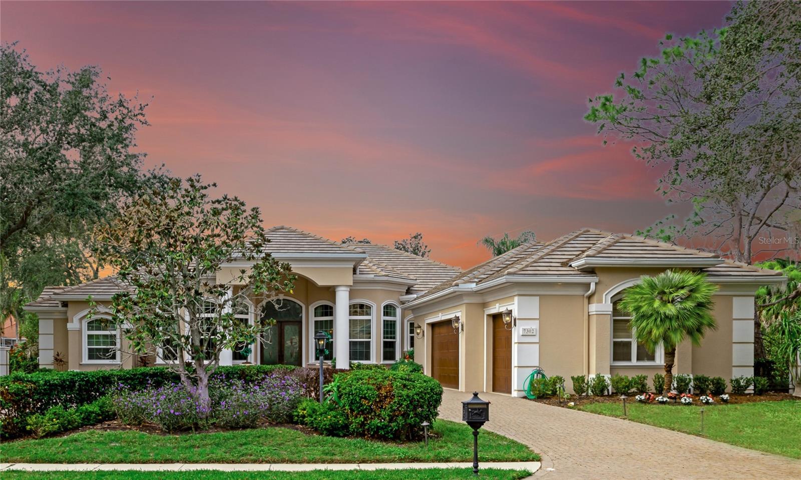 Price reduction. Discover the timeless elegance and luxury craftsmanship of this 3 bedroom, 3.5 bath, 3 car garage, 4,193 square foot estate-home located in the prestigious and private Hyde Park section of highly desirable University Park. A former model home by luxury homebuilder Najjar, this luxury residence is “dressed to the nines” with impeccable finishes and enduring upgrades built to last with unparalleled artistry. This residence is a testament to luxury living, offering stunning lake views and a host of recent upgrades that redefine sophistication in an updated home. Situated on a delightful end lot, the home borders a large association-owned green area, exquisitely maintained with beautiful lawn and landscape, providing a maintenance-free second space for playful pets and children alike. A new roof, new HVAC, and new windows and sliders ensure peace of mind and a secure living environment. A circular driveway leads to custom double front doors, revealing a grand entrance with travertine flooring, an arched ceiling, and double columns, setting the stage for the opulence within. Inside, the beautiful diagonal travertine stone flooring continues, gracing the living room, dining room, kitchen, and family room, creating a seamless flow of luxury throughout the main living spaces. Wood floors accentuate the office, den, and owner's retreat, adding warmth and character to these intimate areas. Solid wood doors and trim are evidence of the master craftsmanship you just can’t find in new homes at this price. The interior is adorned with custom tray ceilings, fine solid-wood cabinetry, and bespoke paint accents, creating a visual masterpiece with character at every turn. The chef's kitchen is a culinary delight, featuring a Sub-Zero refrigerator, Thermador double oven with convection option, 5-burner gas cooktop, quiet Bosch dishwasher, wine cooler, large hidden pantry, custom glazed kitchen cabinets, and stone countertops. Enjoy breakfast in the charming niche with a large aquarium window that frames the pool and lake view. Each bedroom is ensuite, with the owner's retreat boasting a large sitting area, a huge walk-in closet with built-ins, new electric blinds, and a master bath that indulges with a large Jacuzzi soaking tub and a his and her walk-in shower. The home also features a spectacular office space, with rich wood flooring, solid-wood cabinets, and a large executive desk with a black granite countertop—a true wow factor for those seeking a refined workspace. A huge bonus room provides space for movies, play, or a second office with a built-in desk with sunset views. Step outside to an oversized lanai with wood plank ceilings, an expansive travertine deck with multiple seating areas, a custom pool and spa and double water feature, and a summer kitchen with a Viking grill. A meandering path reveals an outdoor seating area for two, a quiet place to enjoy the views with the one you love. With a large 3+ car garage, this home stands as one of the finest offerings in the prestigious University Park. University Park stands as a private, residential gem, recognized as one of the pre-eminent communities in the Bradenton/Sarasota area. Gated and manned 24/7 by on-site staff, with limited access, the community ensures security and exclusivity. For added convenience, a nearby back gate at Honoré Avenue, is exclusive to residents and Country Club members, facilitates smooth entry and exit. Schedule your private showing!